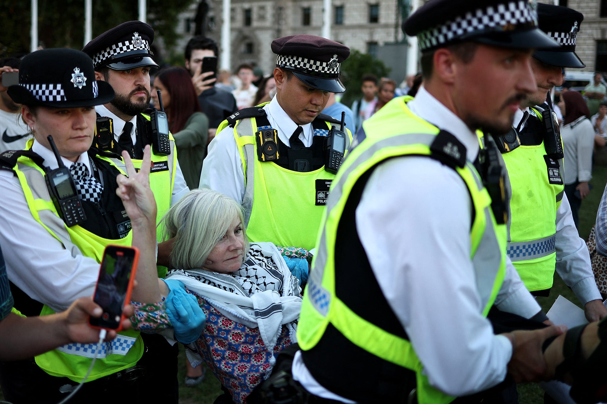 <p>A protester is carried away by police officers at a demonstration in support of Palestine Action on Saturday</p>