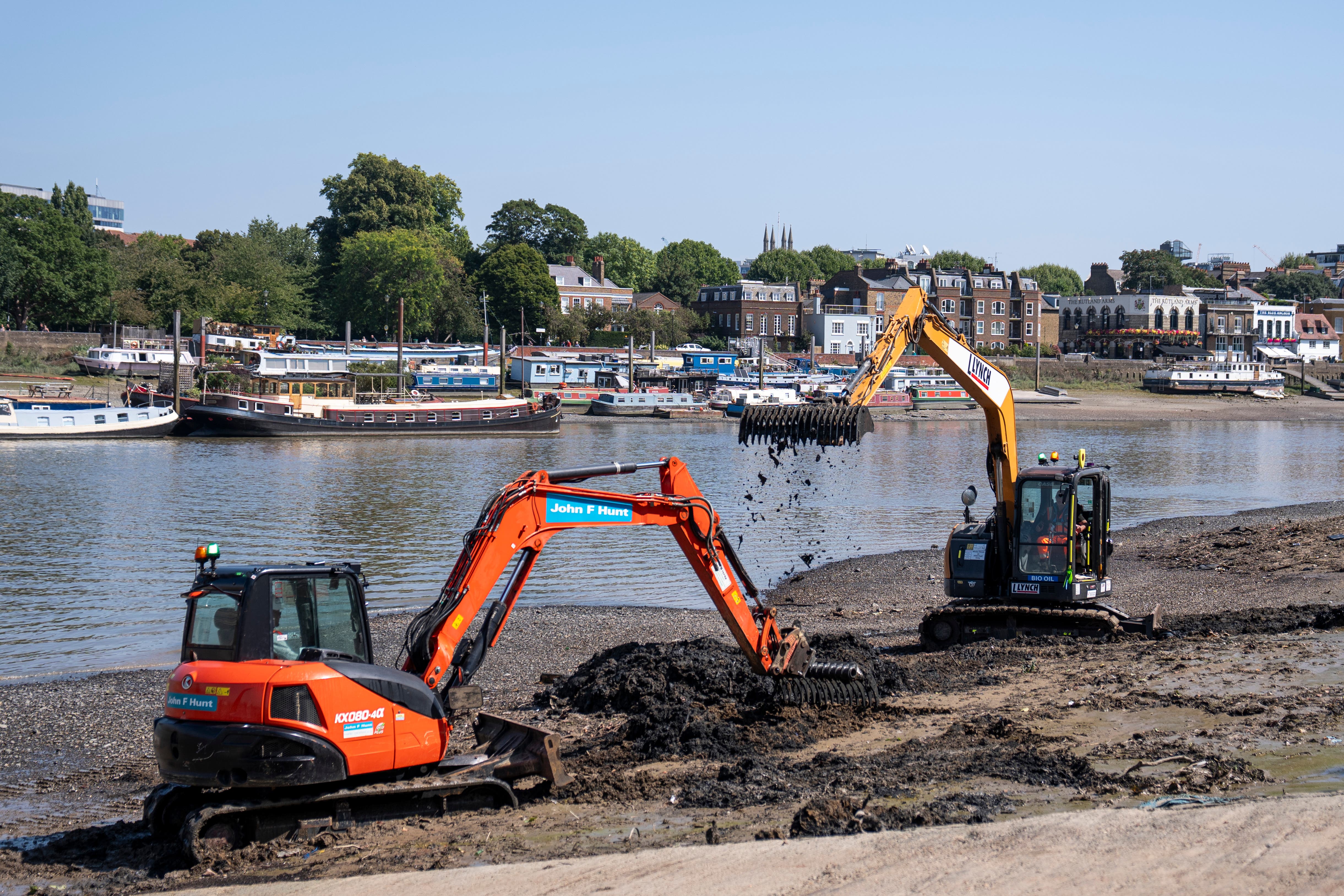 Construction workers at the launch of the first mass wet wipe removal from a UK river (Ben Whitley/PA)