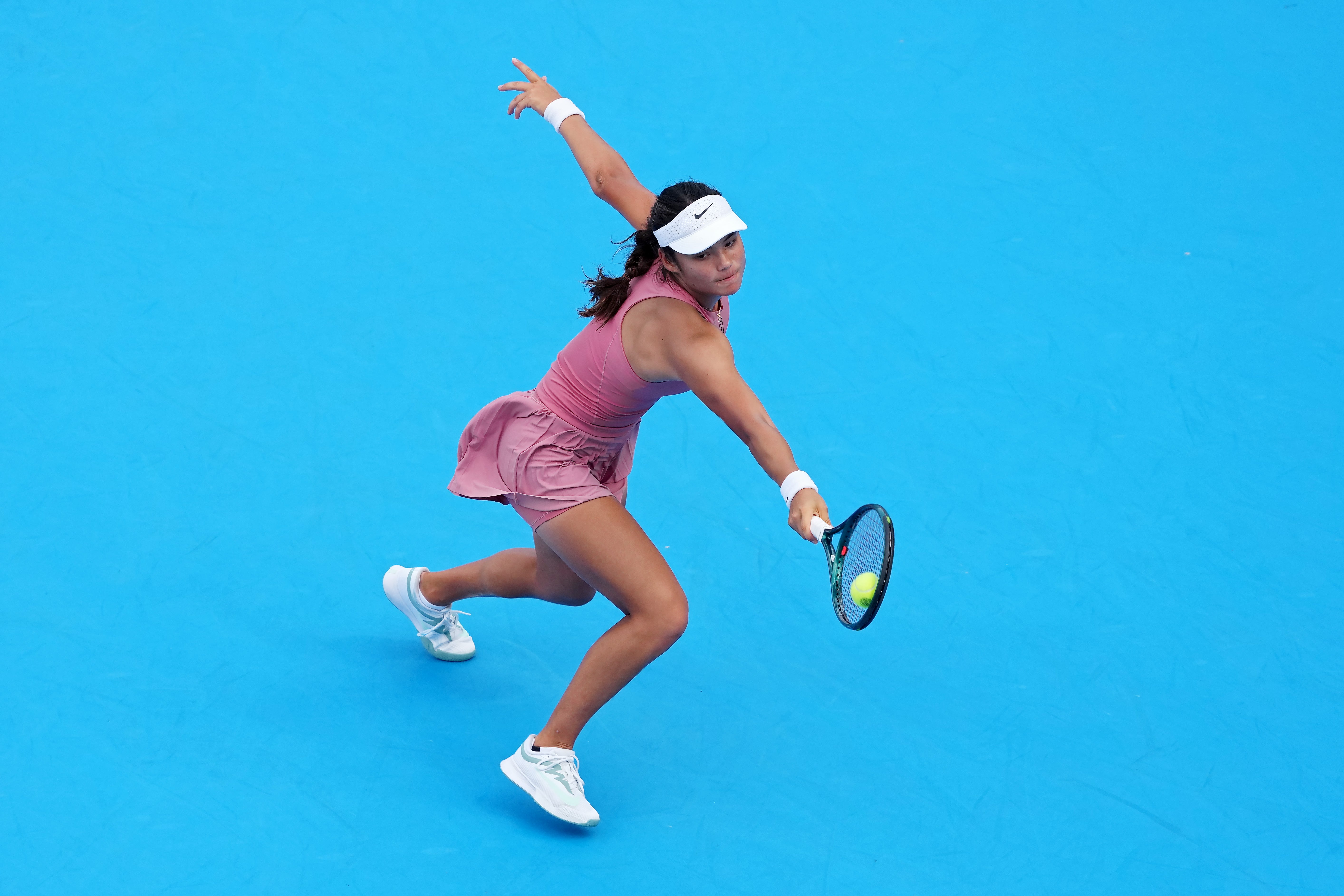 Raducanu reaches for a backhand