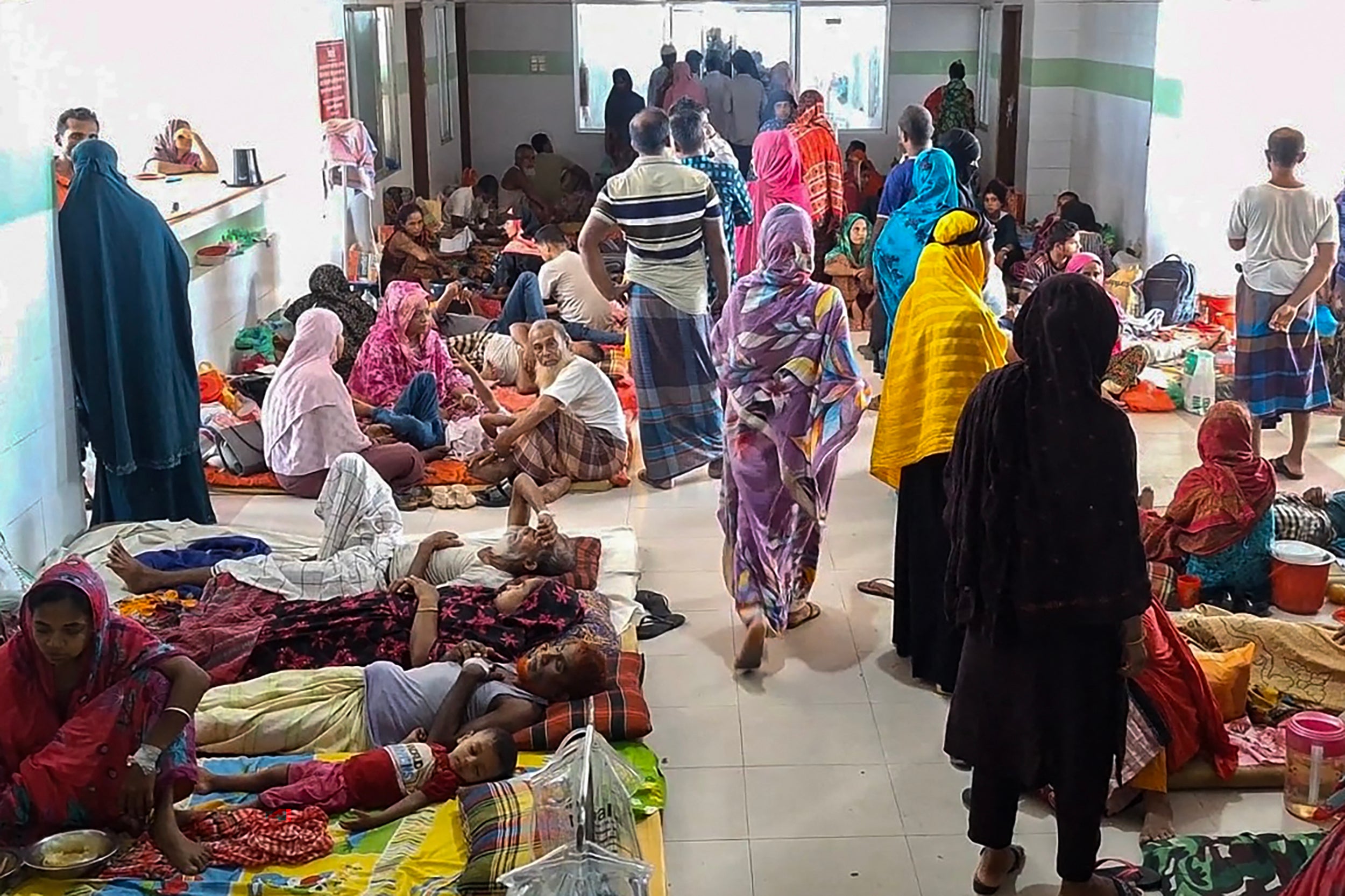 Dengue patients along with their family members are pictured at a hospital in Barguna in southern Bangladesh on 22 June 2025