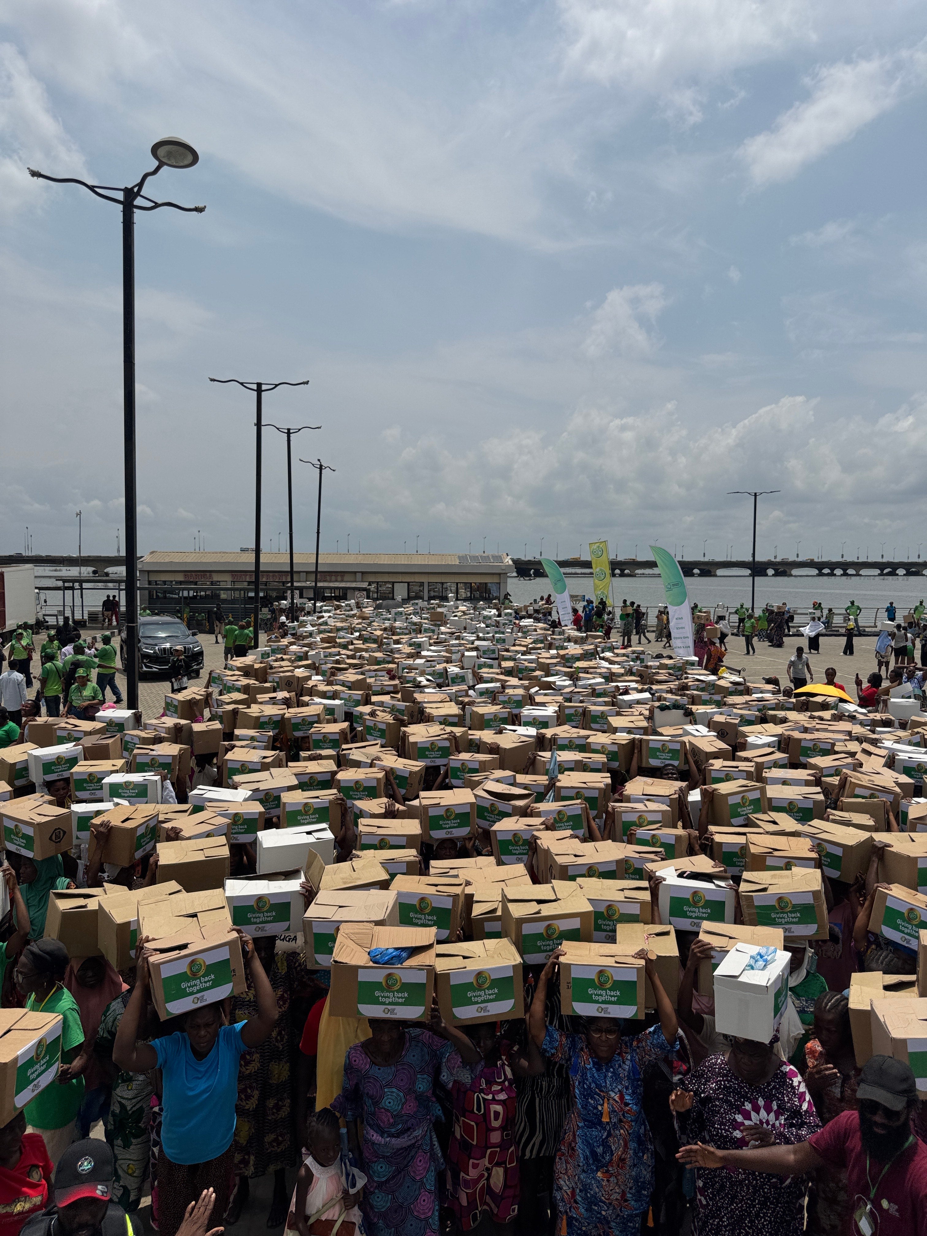 Women prepare to carry food parcels home at a time when demand is surging
