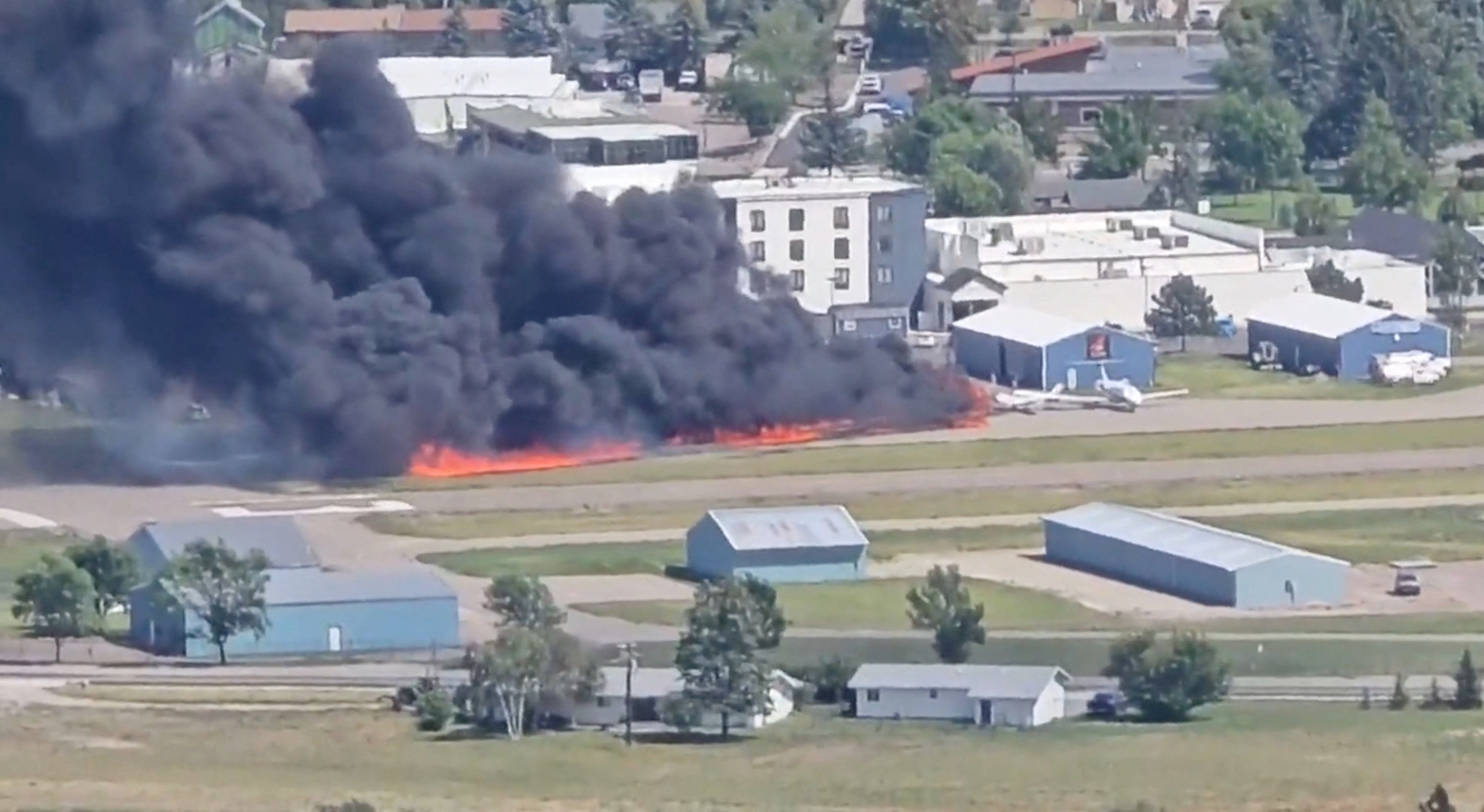 Plane carrying four hit runway ‘like a Frisbee’ and skid into parked plane, starting a fire, officials said