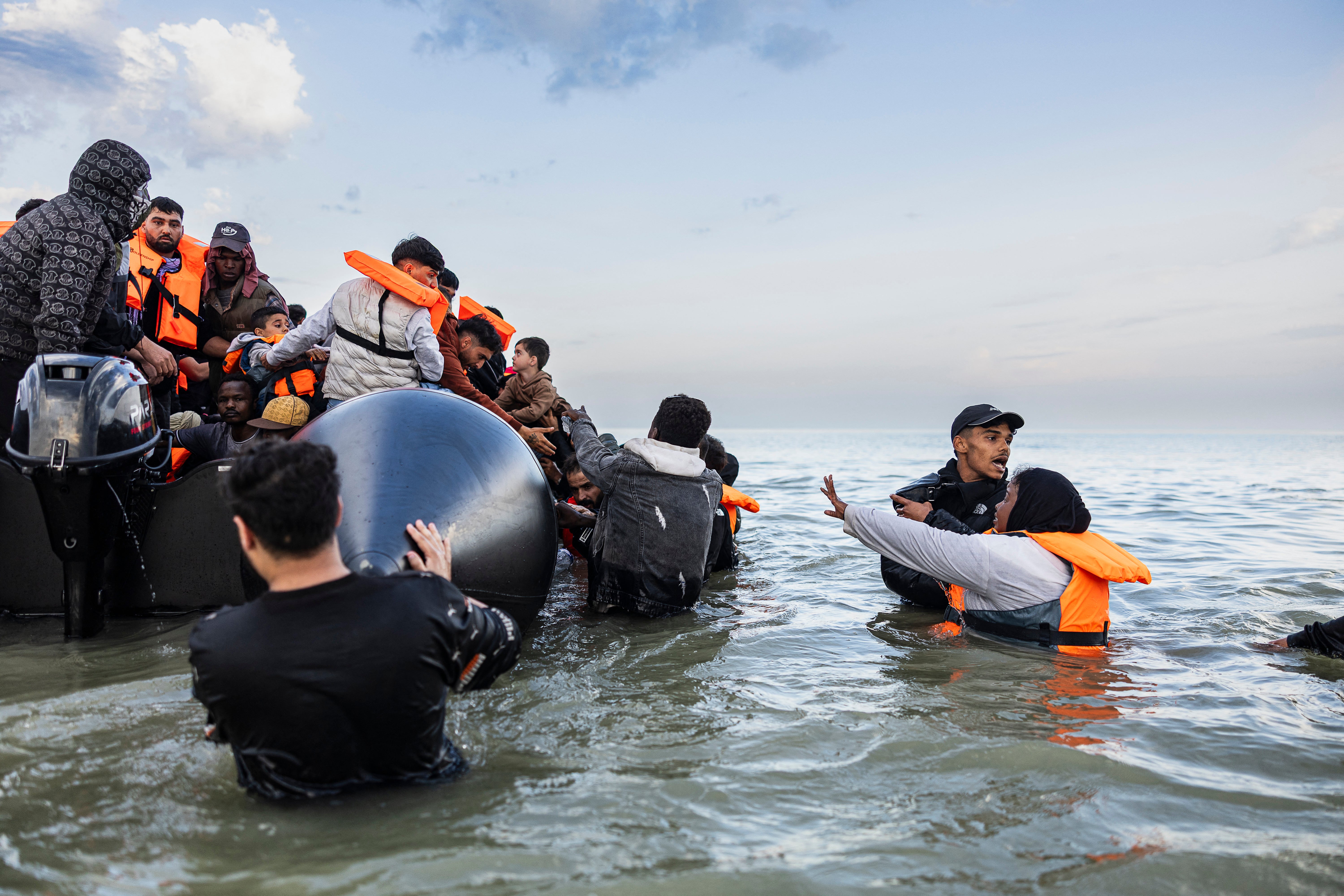 Migrants in northern France try to board a boat to cross the English Channel