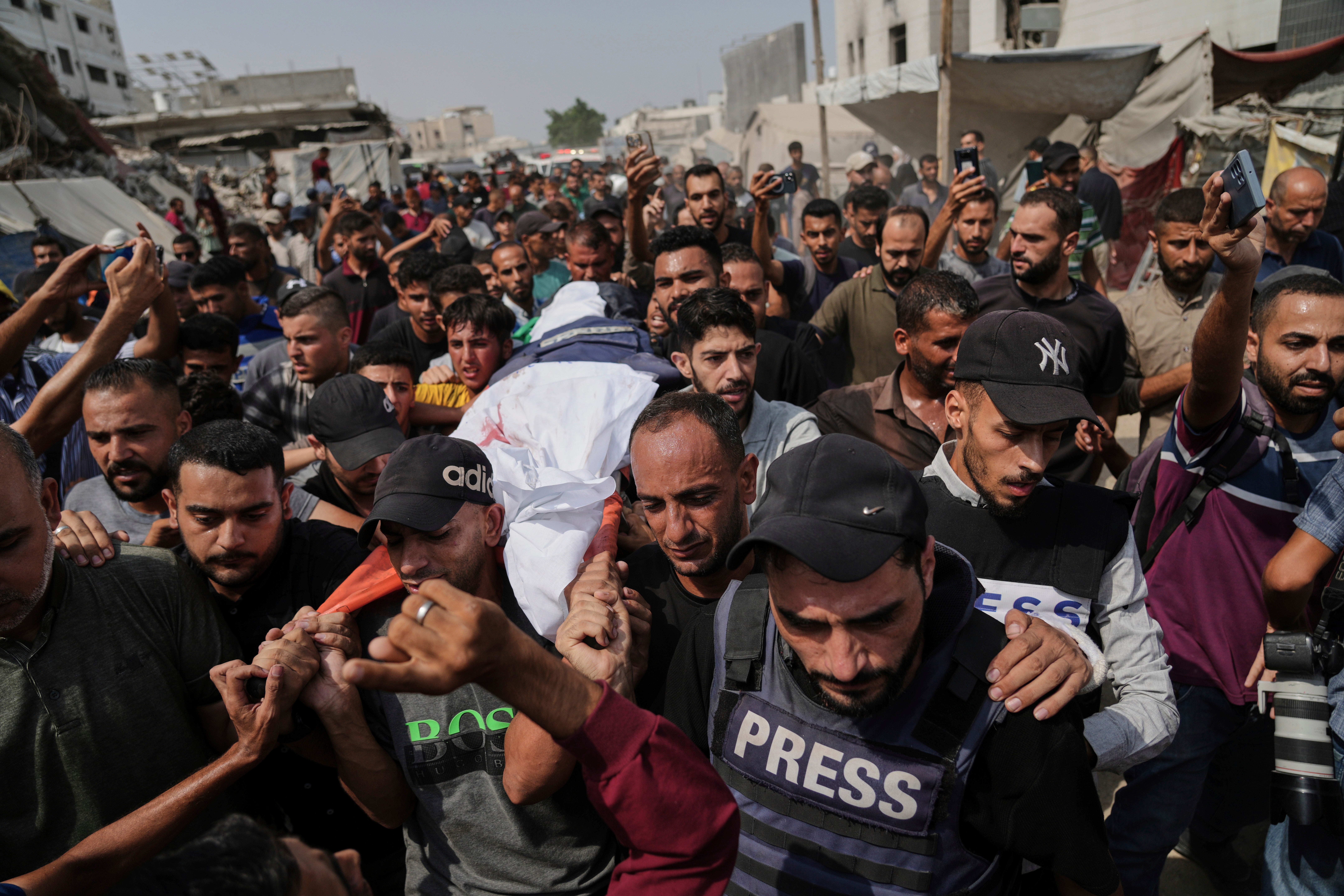 Palestinians carry the body of Al Jazeera correspondent Anas al-Sharif at his funeral outside Gaza City's Shifa hospital complex, Monday, Aug. 11, 2025. (AP Photo/Jehad Alshrafi, File)
