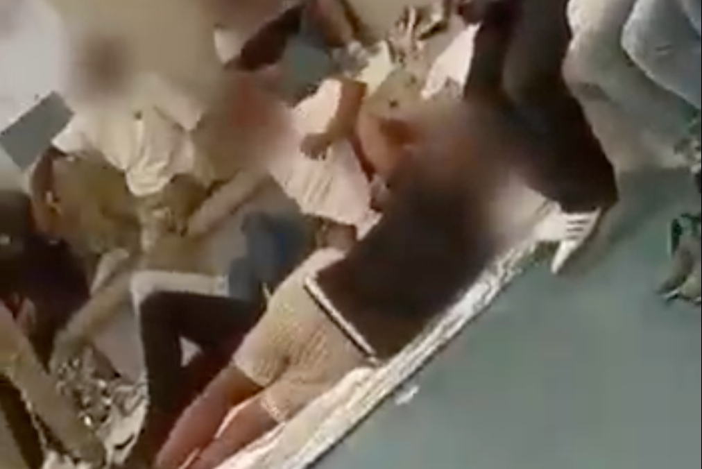 Video from inside the holding facility shows detainees lying on nothing but thin sheets with emergency blankets, with two toilets separated from the room by only a waist-high partition