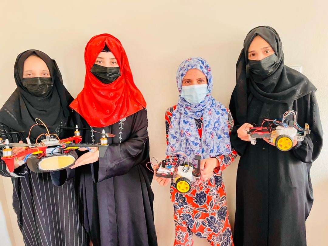 Team members display their prototypes after Taliban restrictions cut their studies short