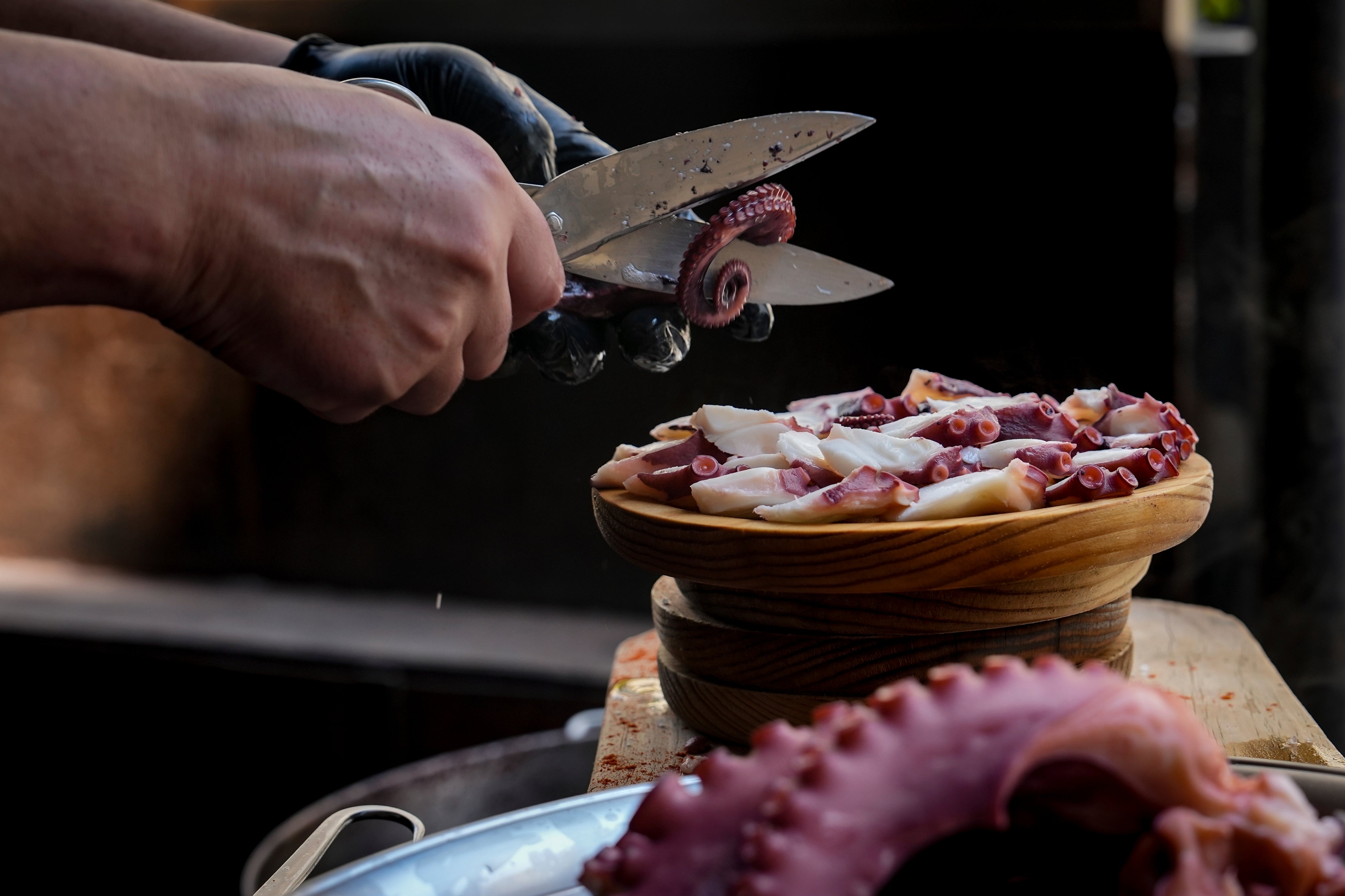 Octopus is prepared at a restaurant on Wednesday, June 25, 2025, in O Carballino, Spain