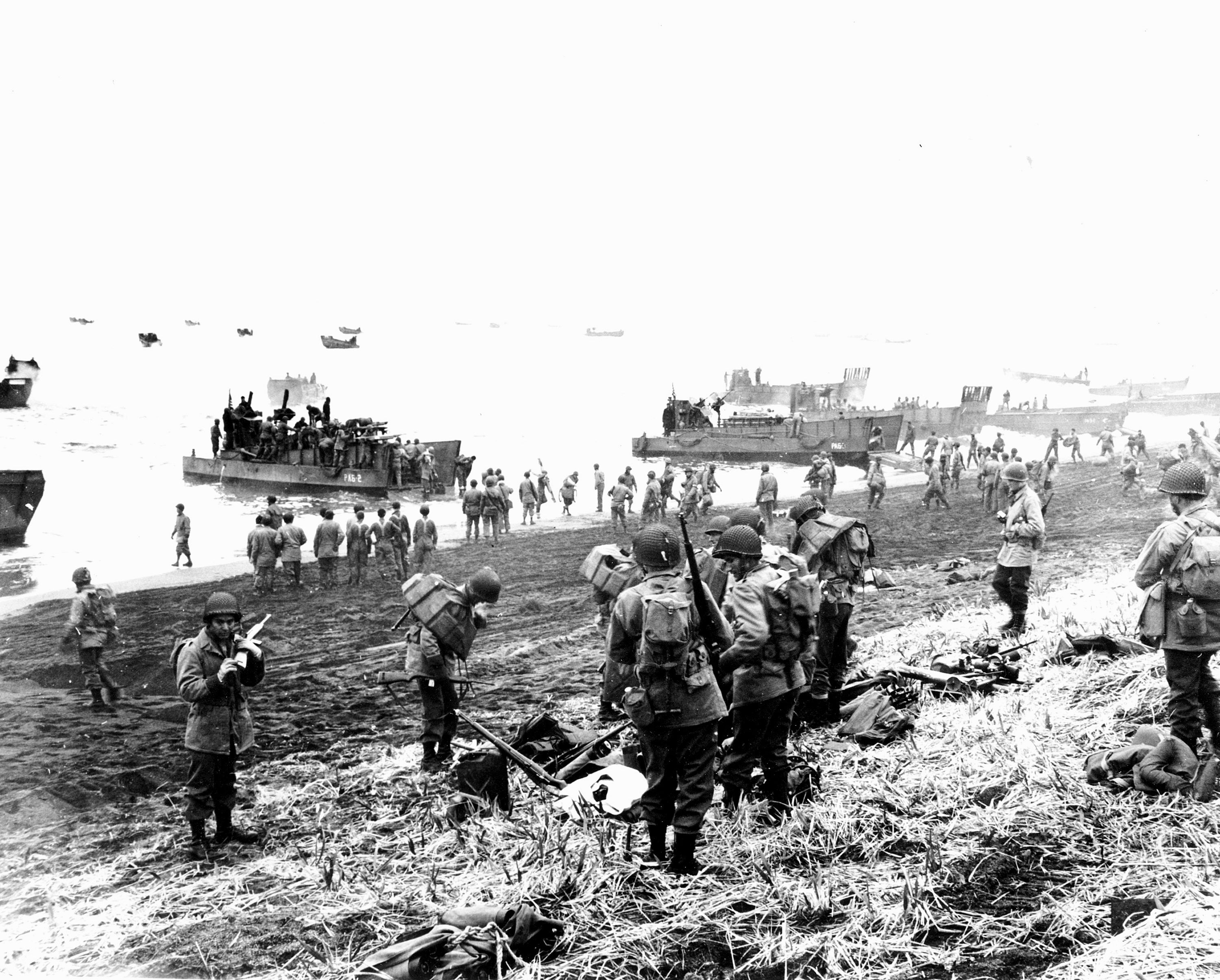 American soldiers land on the black volcanic beach during World War II at Massacre Bay on Attu Island in 1943