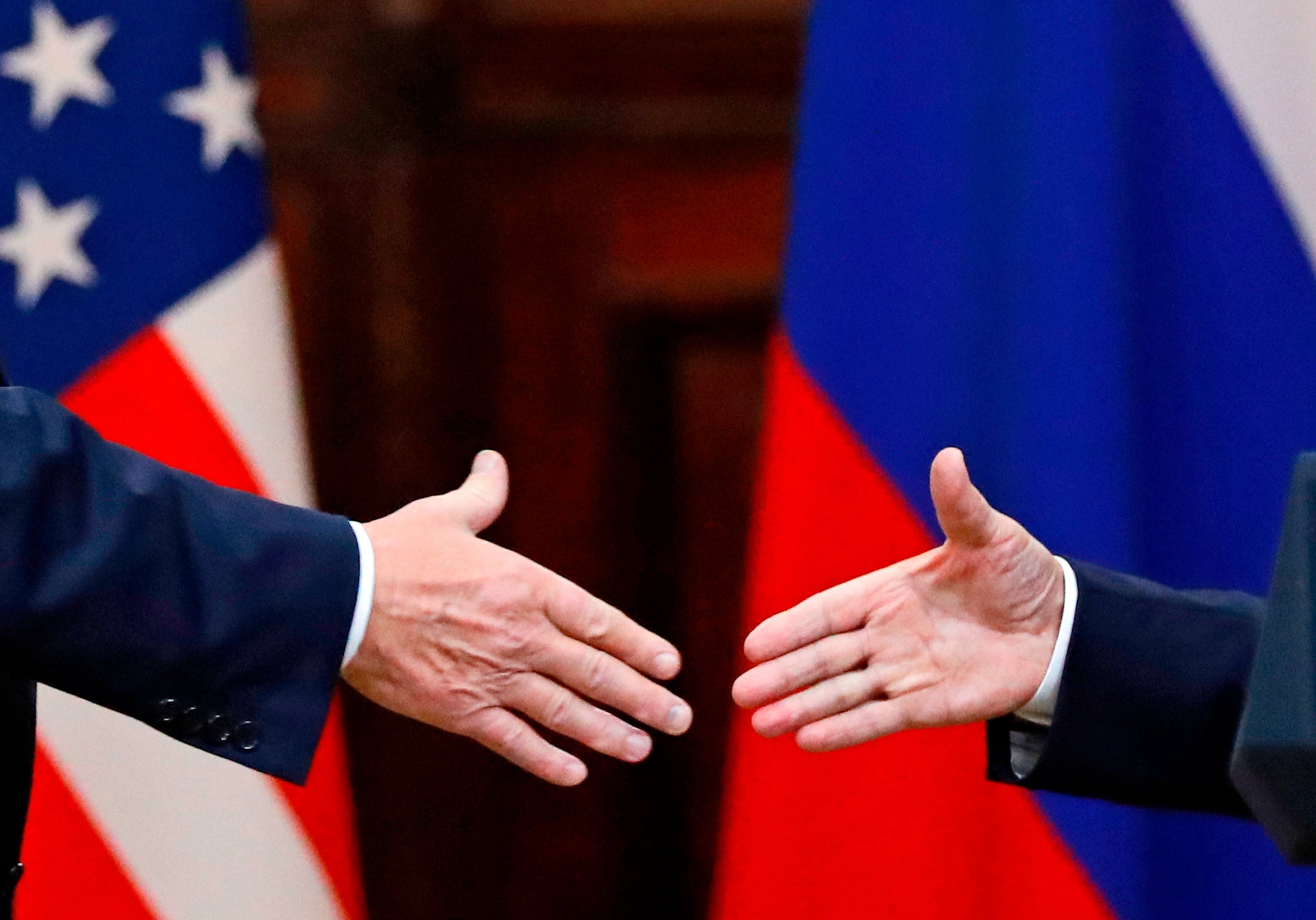 Trump shakes hands with Russian President Vladimir Putin in 2018