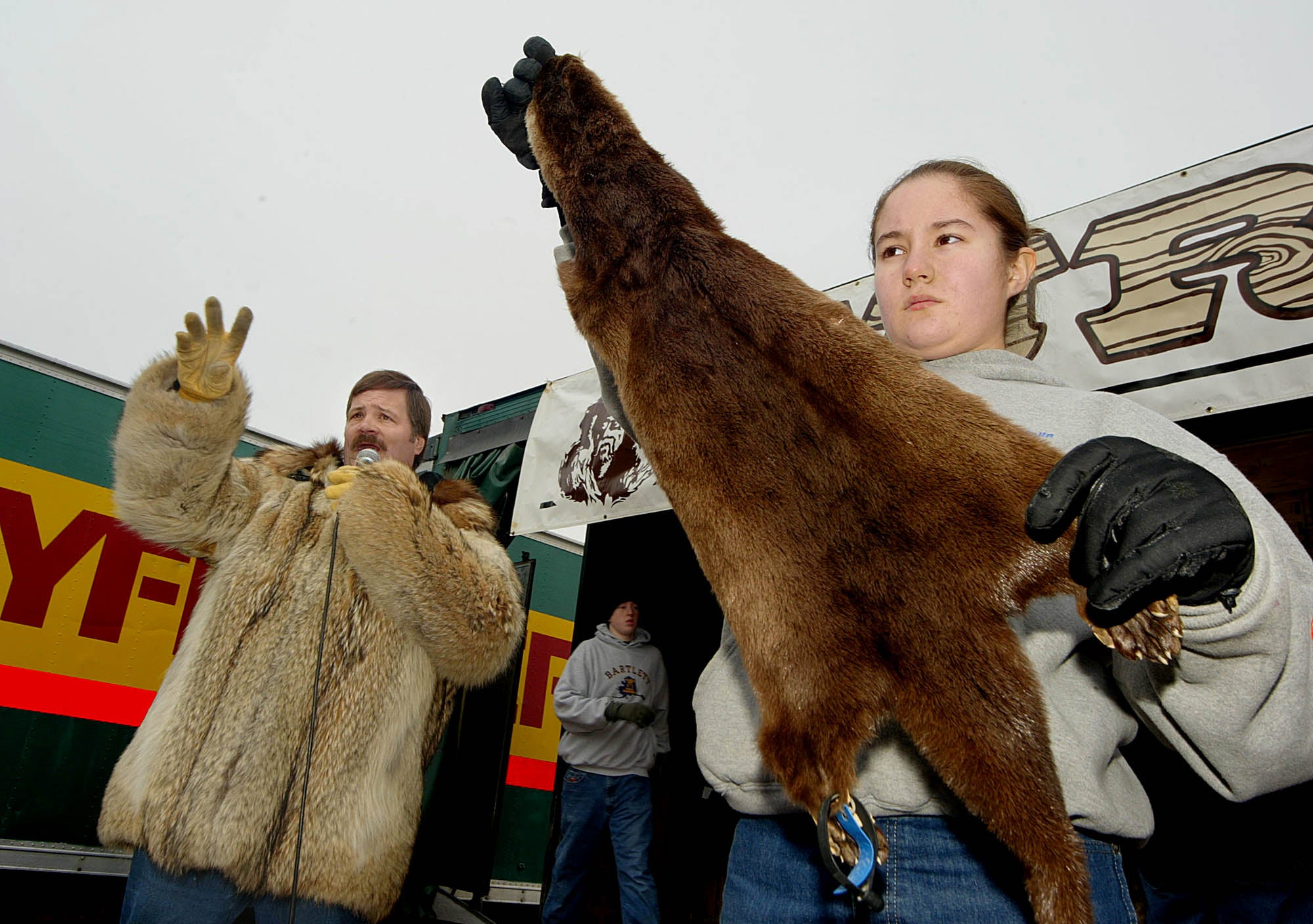 Gloriella Curtis holds up a river otter hide during the Fur Rendezvous annual auction in 2004
