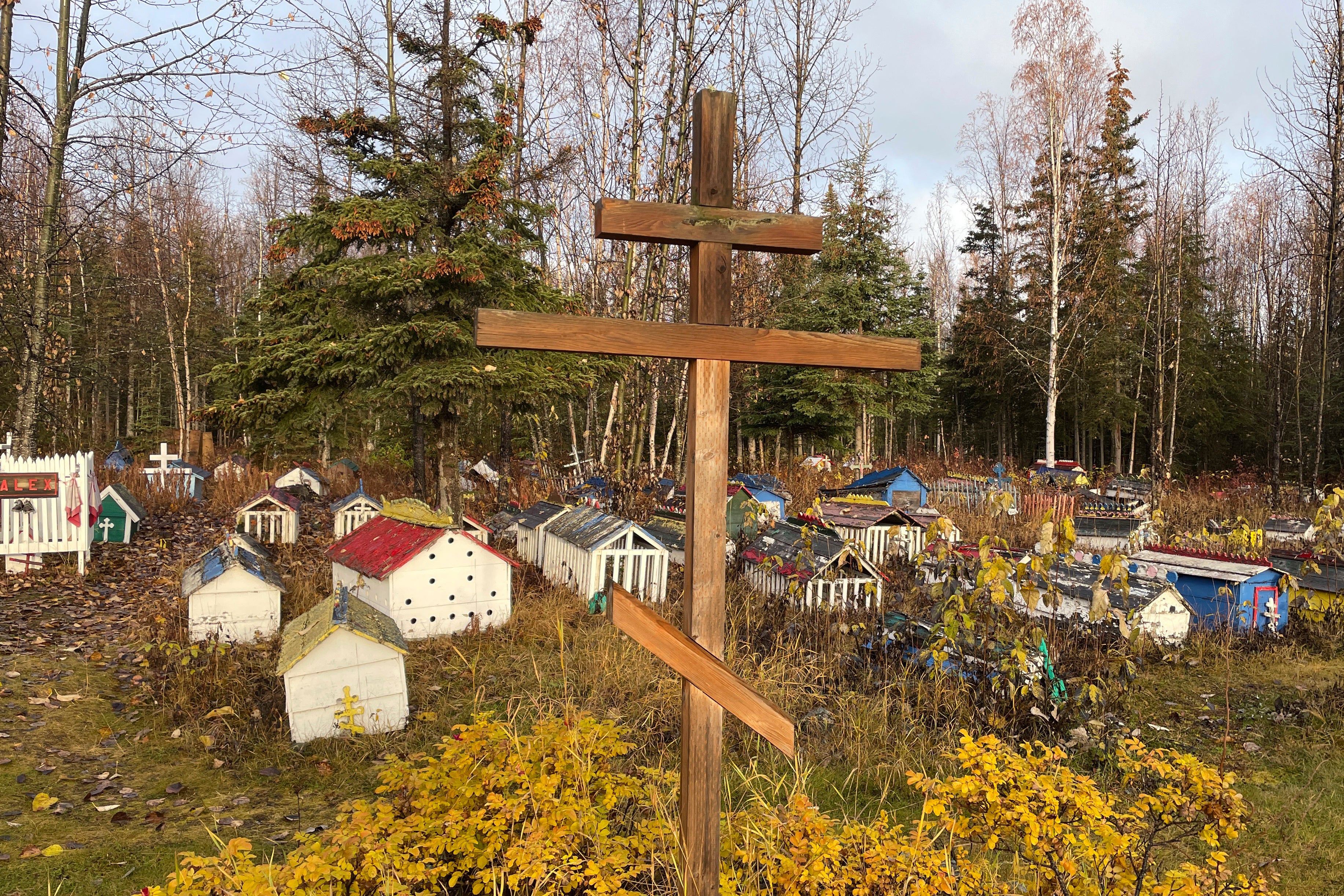 The cemetery at St. Nicholas Church in Eklutna, Alaska, features a mixture of Russian Orthodox conventions