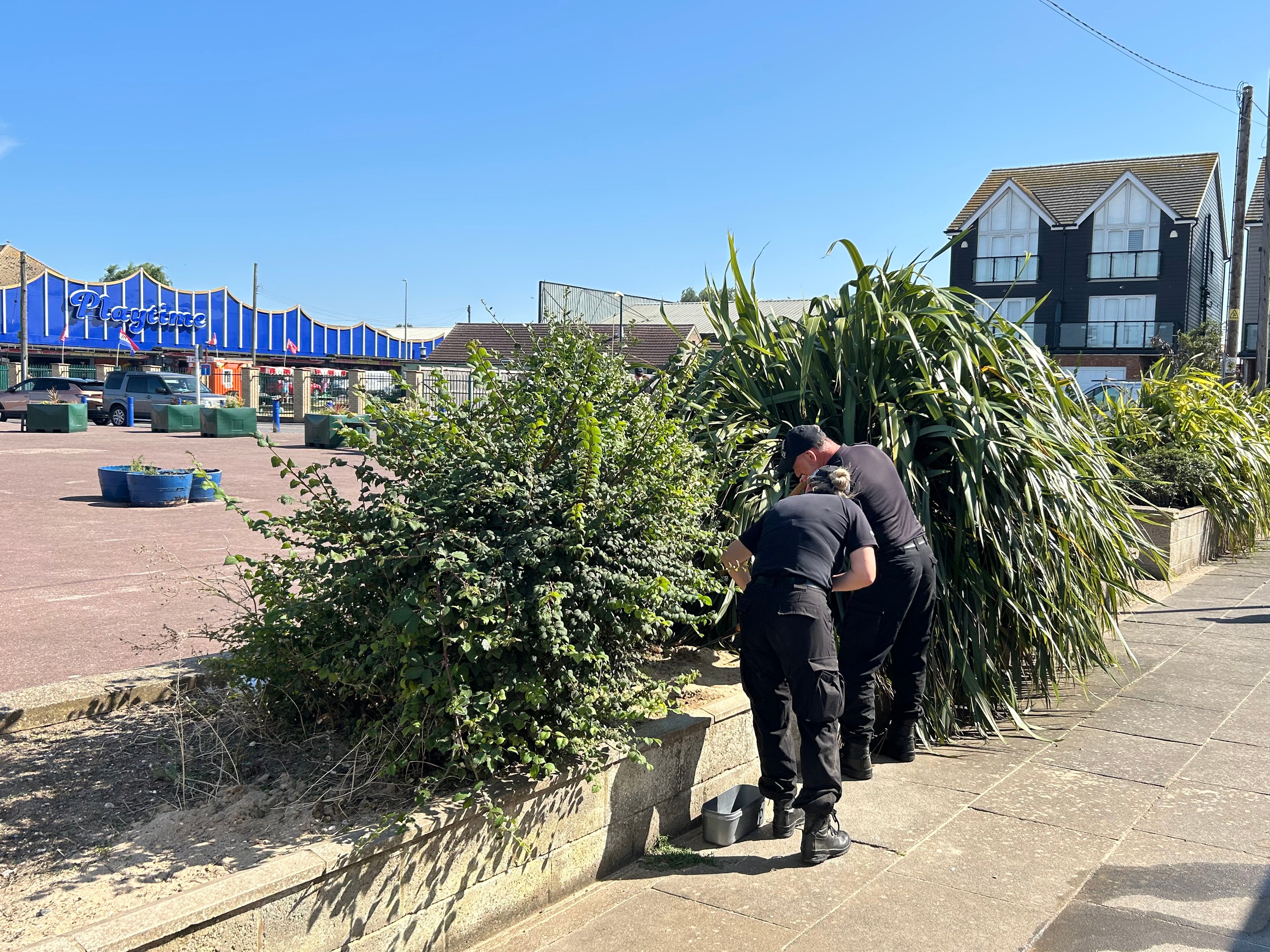 Police officers carry out searches near the scene in the Leysdown-on-Sea resort on the Isle of Sheppey