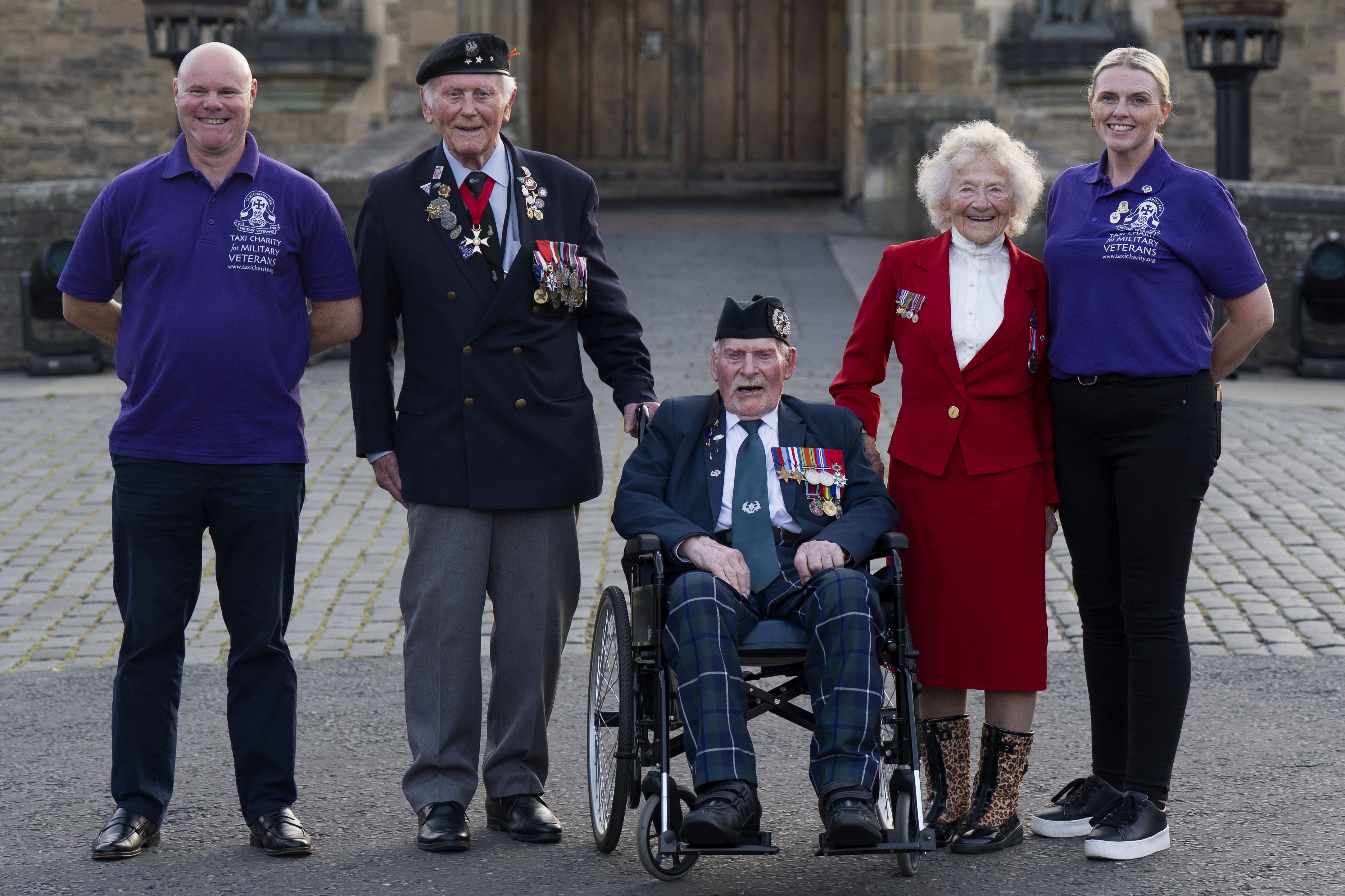 Second World War veterans Eugeniusz Niedzielski, 101, Don Turrell, 100, and Dorothea Barron, 100, met vice chairman Paul Cook (left) and fundraiser and safeguarding officer Keely Allen (right) (Jane Barlow/PA)