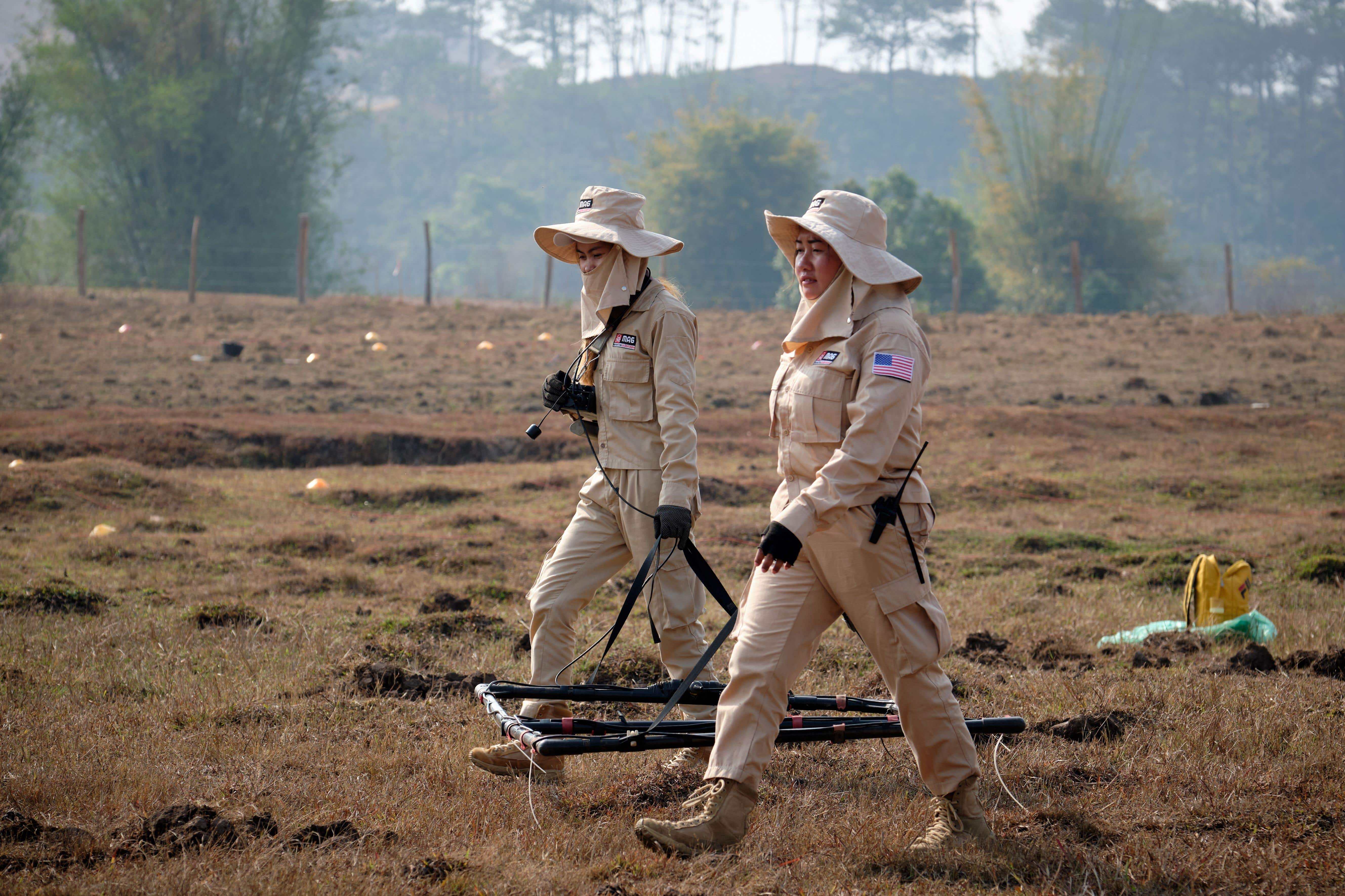 Technicians from the Mines Advisory Group (MAG) search for cluster bombs in Laos (MAG/Bart Verweij/PA)