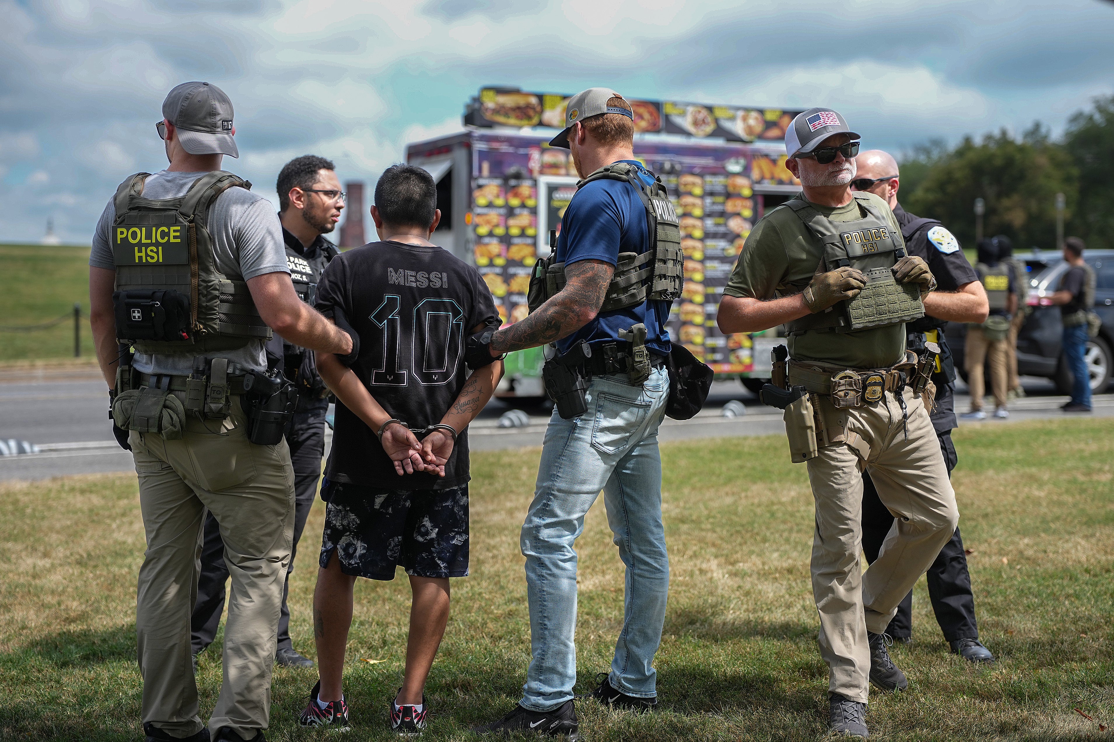 Homeland Security and US Park Police officers detain a person on the National Mall on August 12