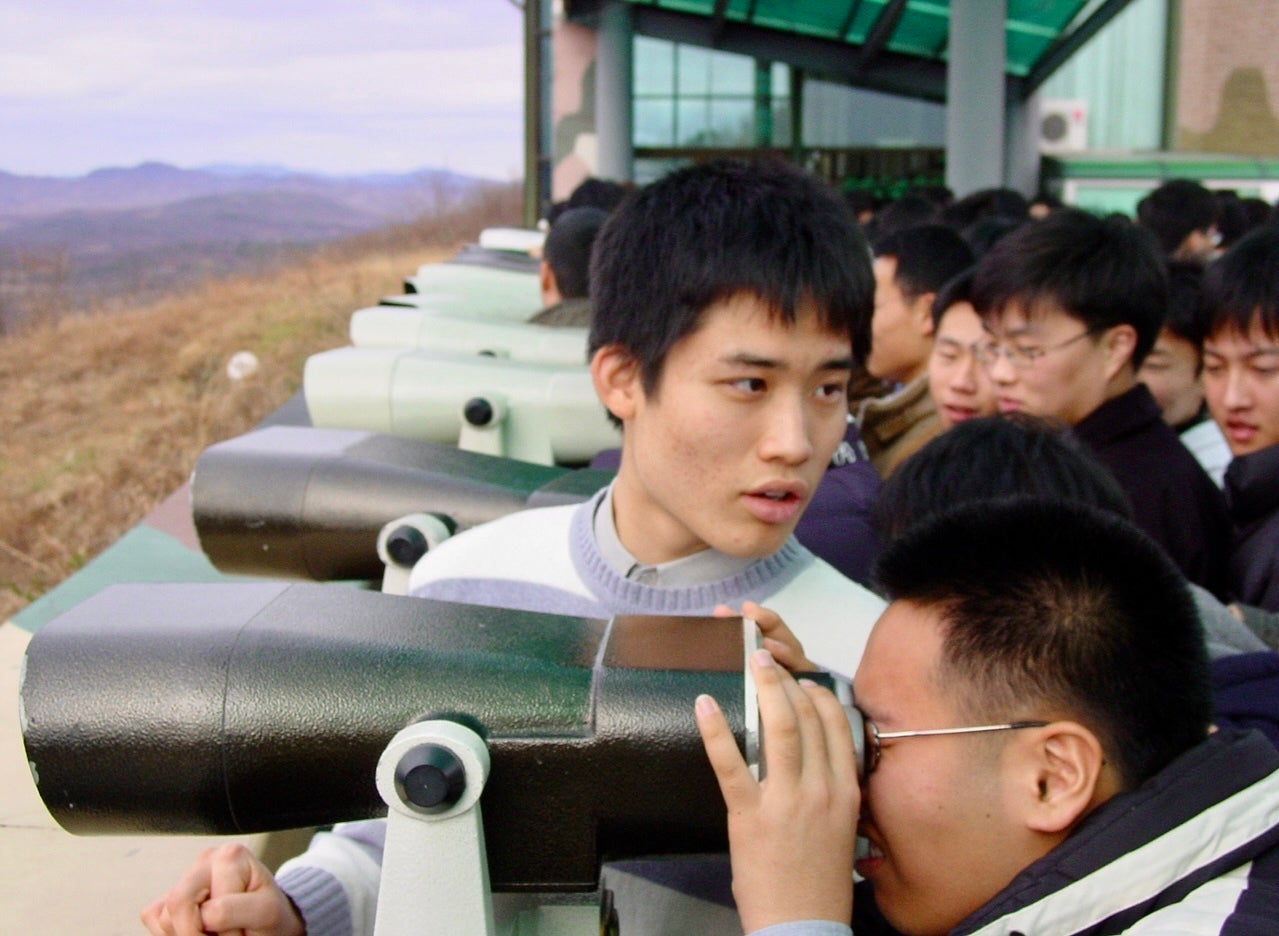 Visitors to Panmunjom look across the border to North Korea