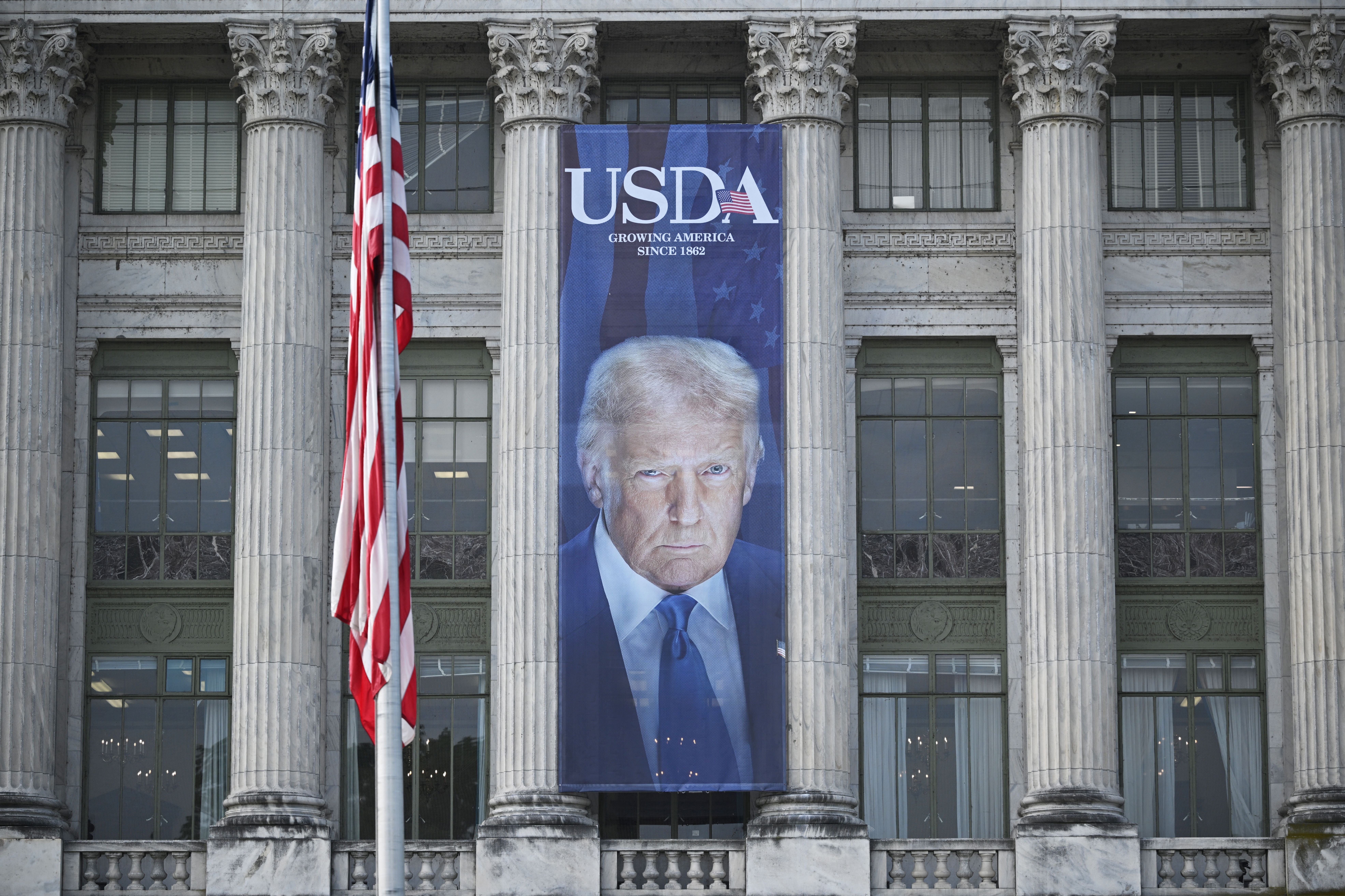 The Agriculture Department spent thousands of dollars on giant banners featuring President Donald Trump’s face as it was cutting aid to schools and food banks, a new report has revealed