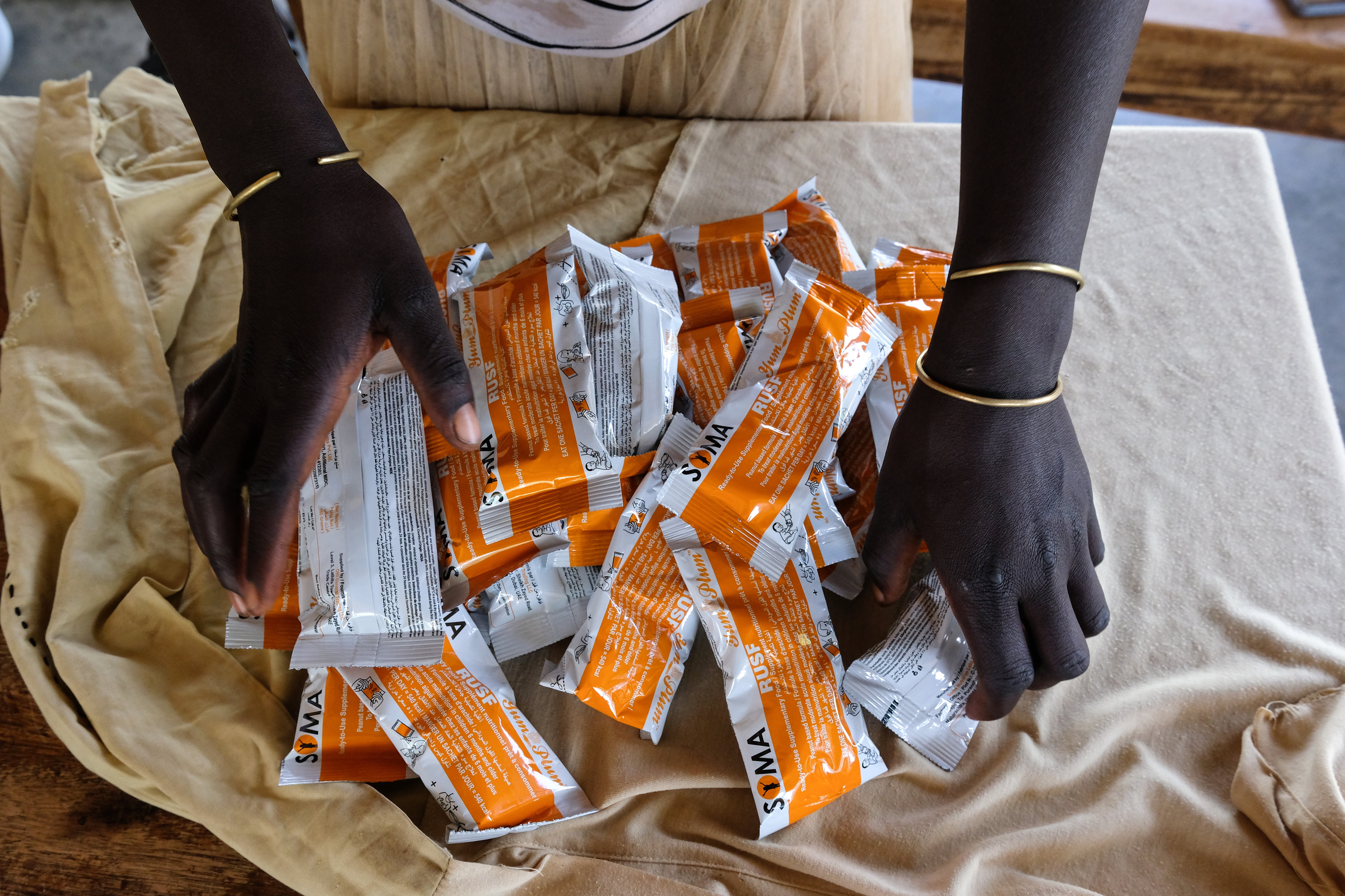 A breast feeding mother in Uganda collects nutritional food for her children through the World Food Program, which faces a projected 40 percent reduction in funding for 2025 after Trump’s cuts, leaving an estimated 58 million people around the world vulnerable to starvation