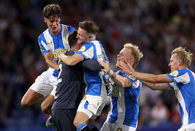 <p>Lee Nicholls ensured Huddersfield progressed in the competition</p>