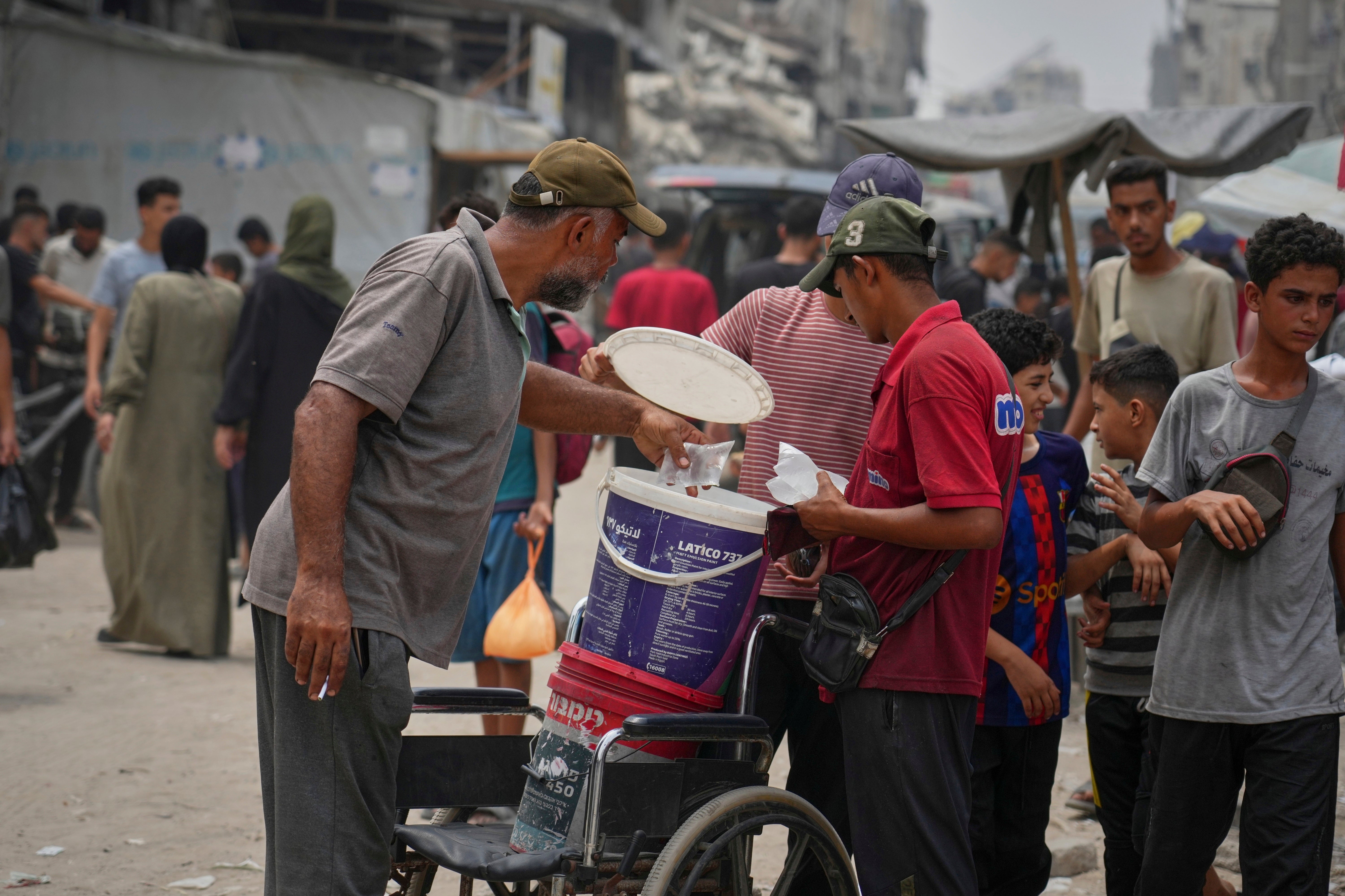 A man sells plastic bags of water for one shekel each in Gaza City earlier this week