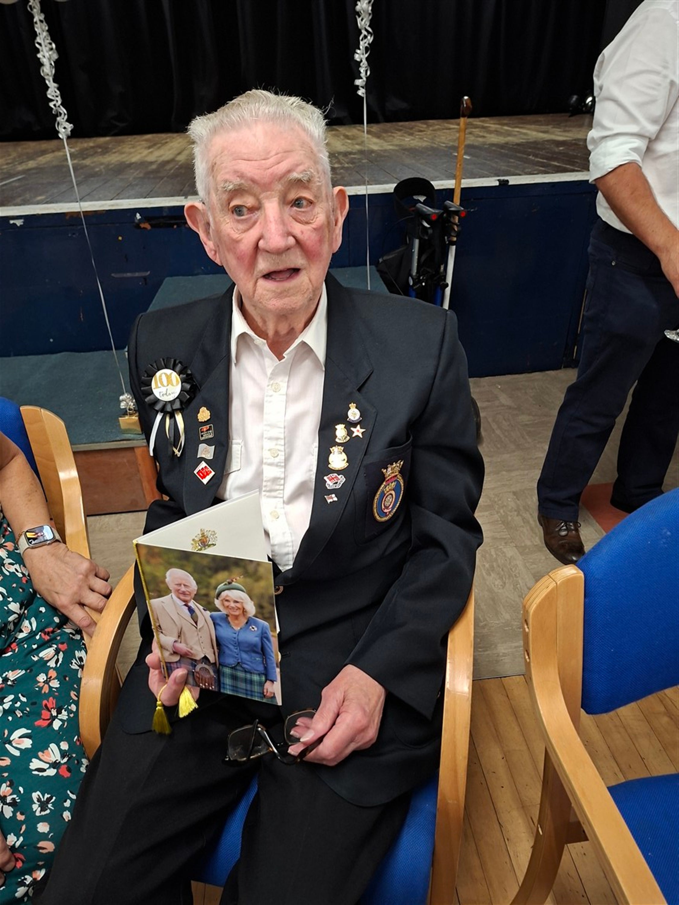 Draper, pictured celebrating his 100th birthday with a card from King Charles III