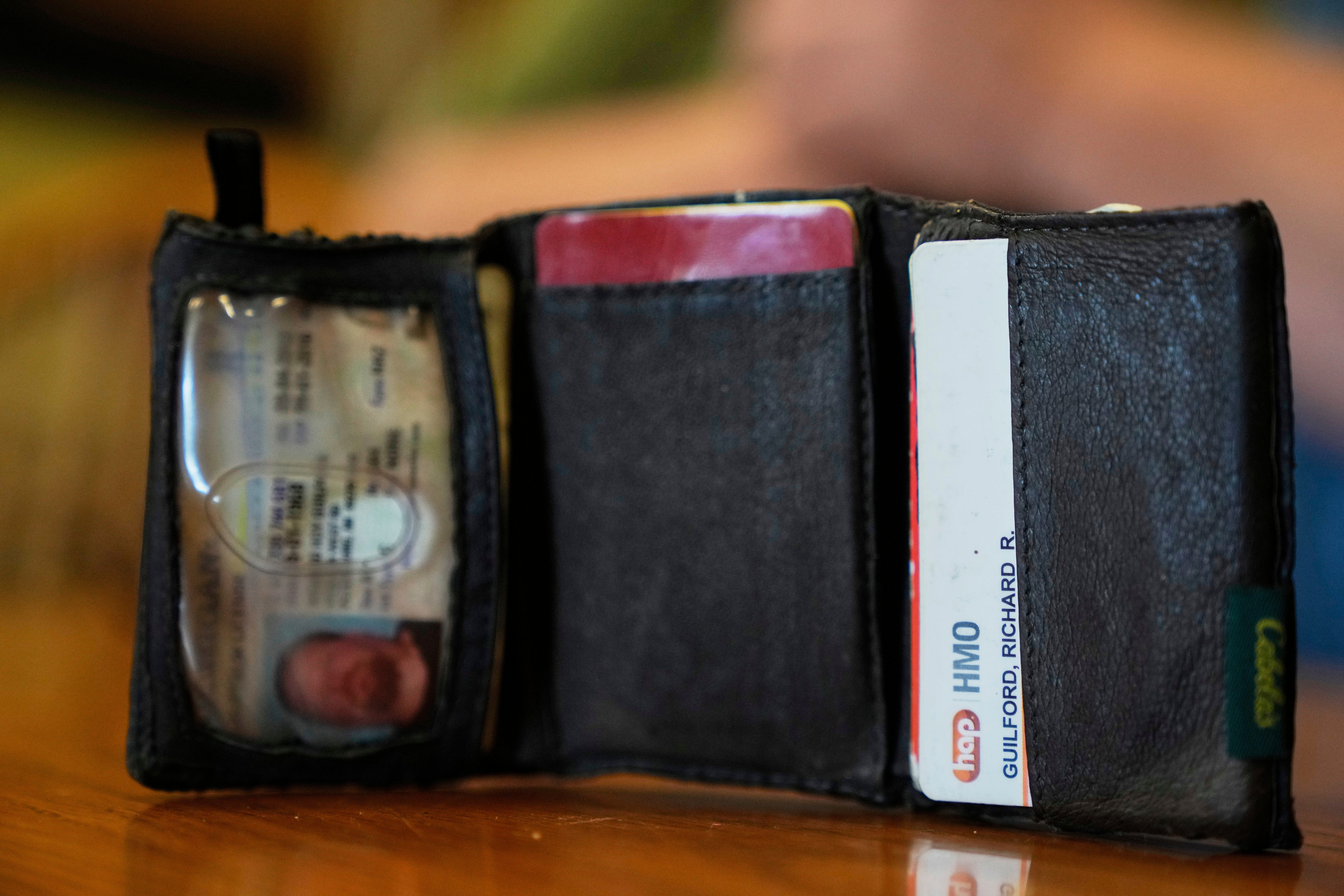 The old wallet of Richard Guilford is seen as he speaks during an interview Thursday, Aug. 14, 2025, in Petersburg, Mich. (AP Photo/Ryan Sun)