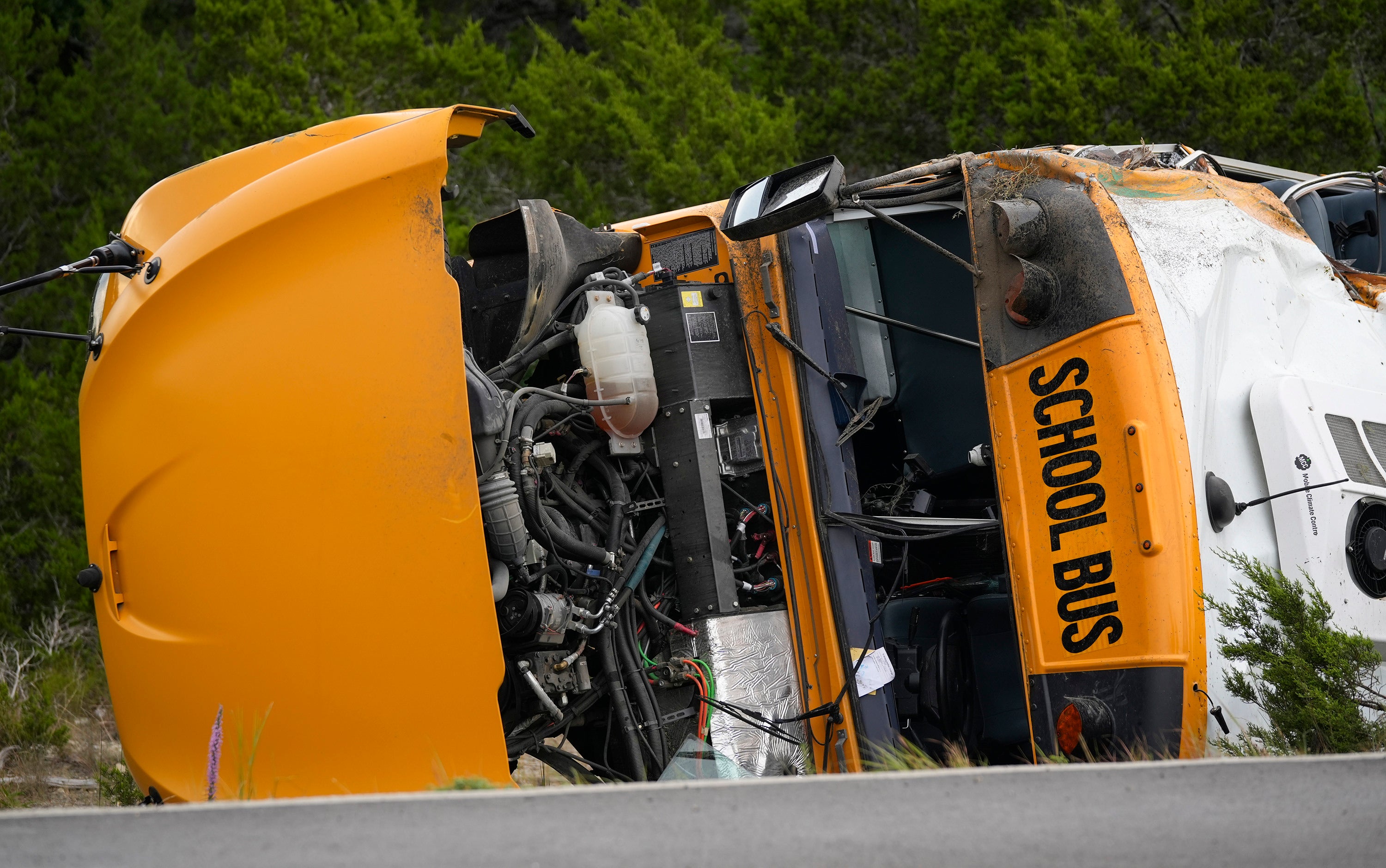 A Leander Independent School District bus lies on its side after crashing in Texas on Wednesday