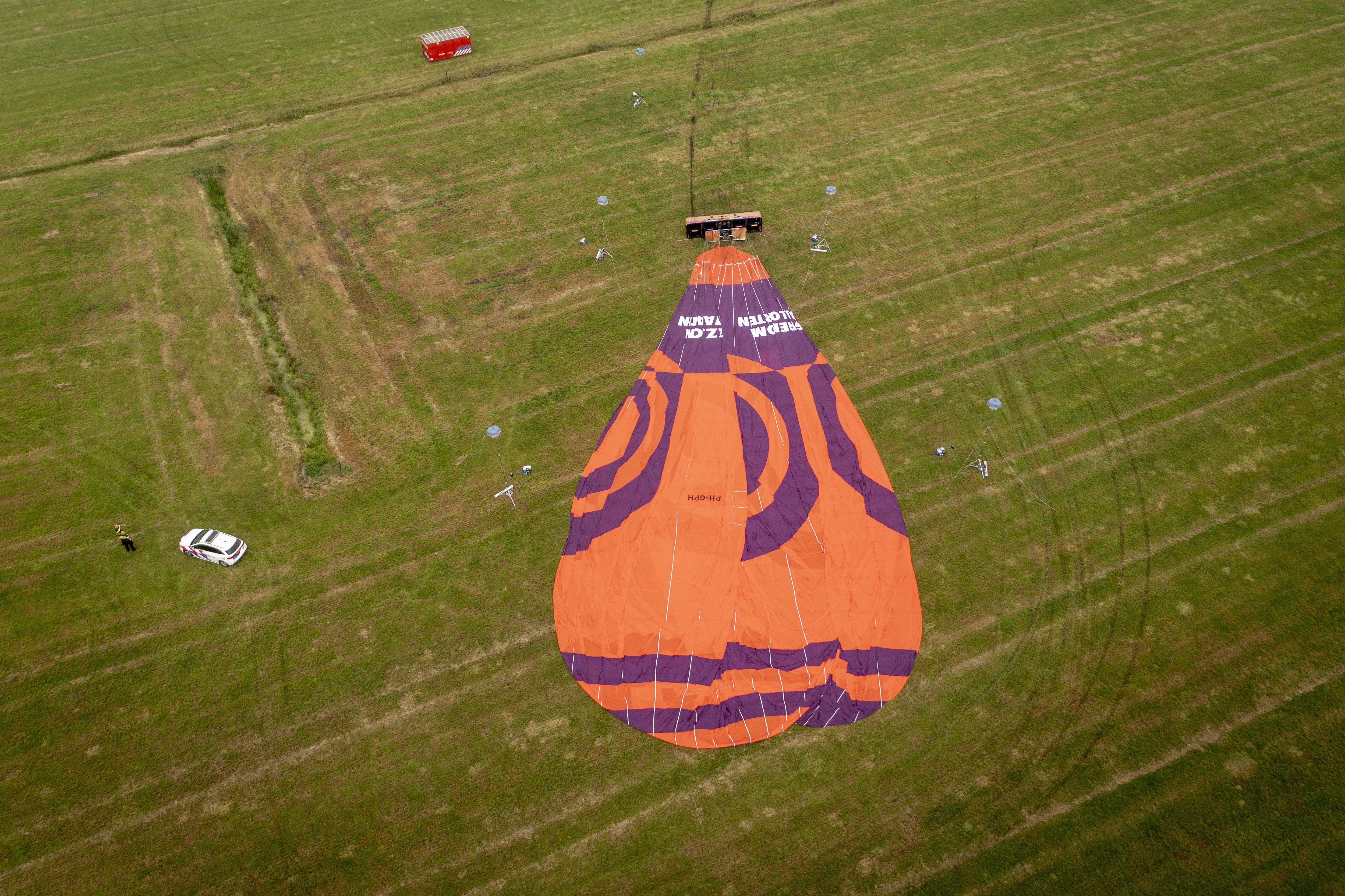 Dutch police officers stand at the scene of a hot air balloon accident near De Hoeve