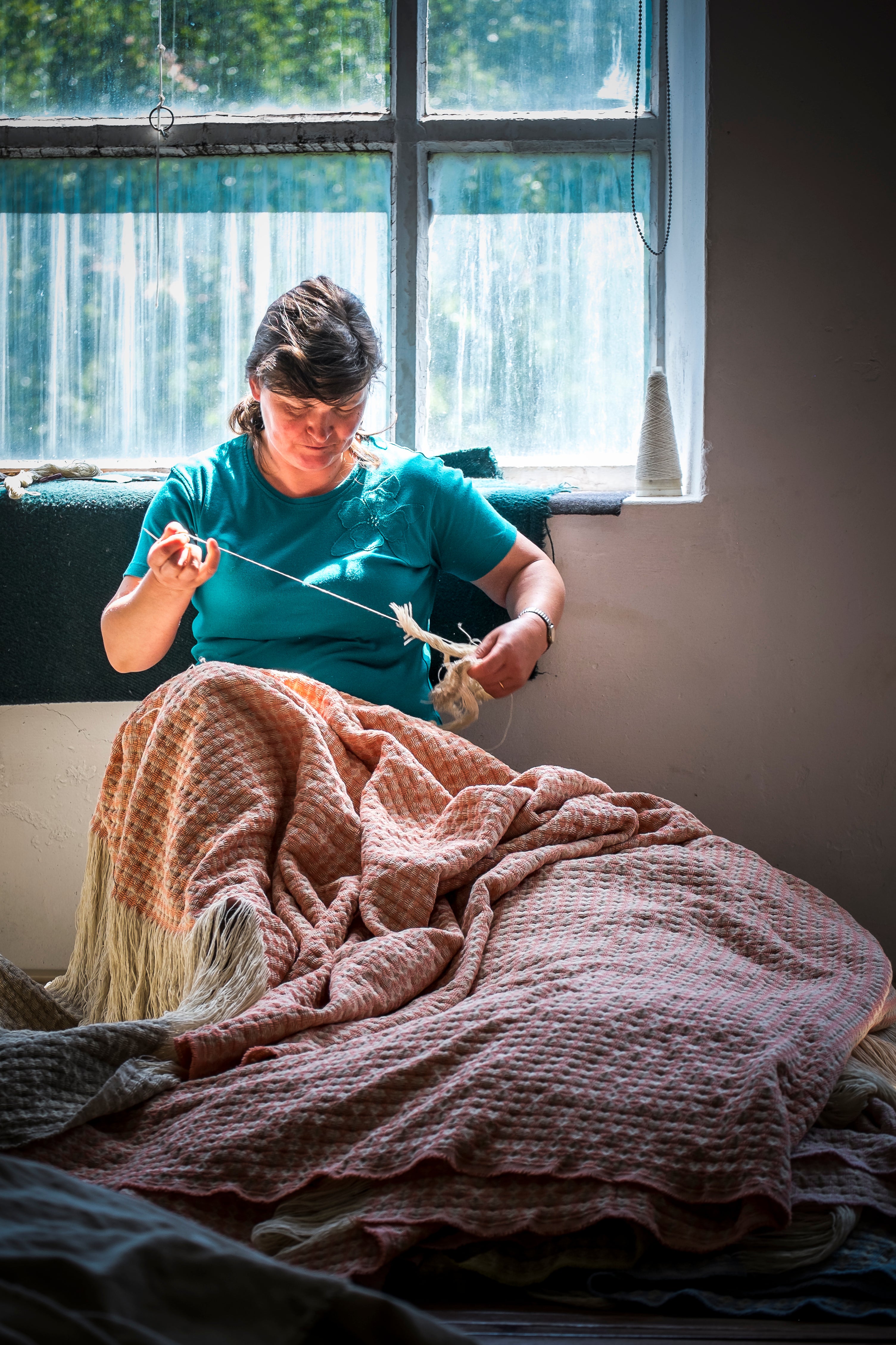 The Burel factory, where a woman works local wool into a blanket in the Portuguese mountains