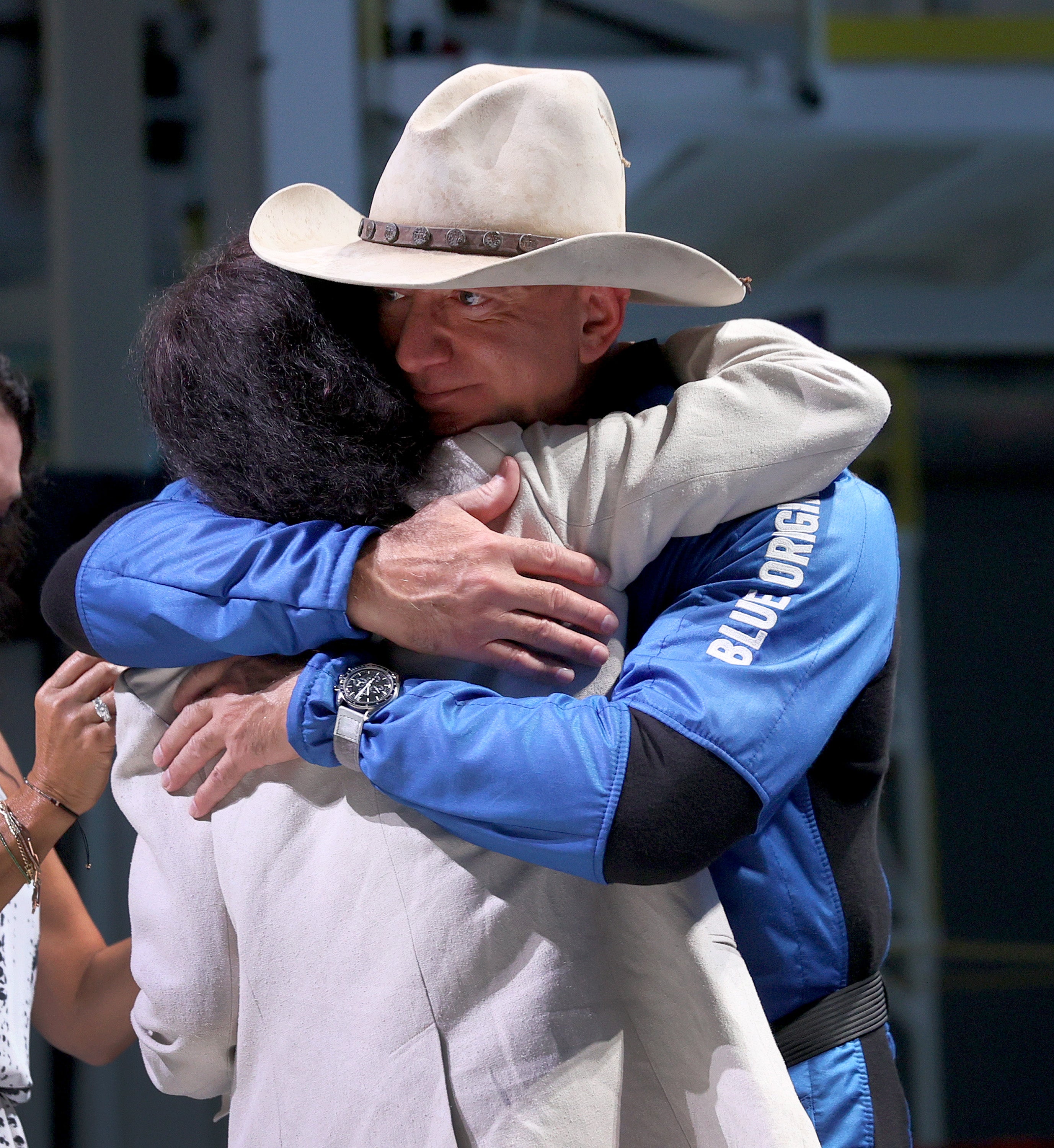 Jeff Bezos hugs his mother, Jacklyn Bezos, after his flight on Blue Origin's New Shepard into space during a press conference on July 20, 2021