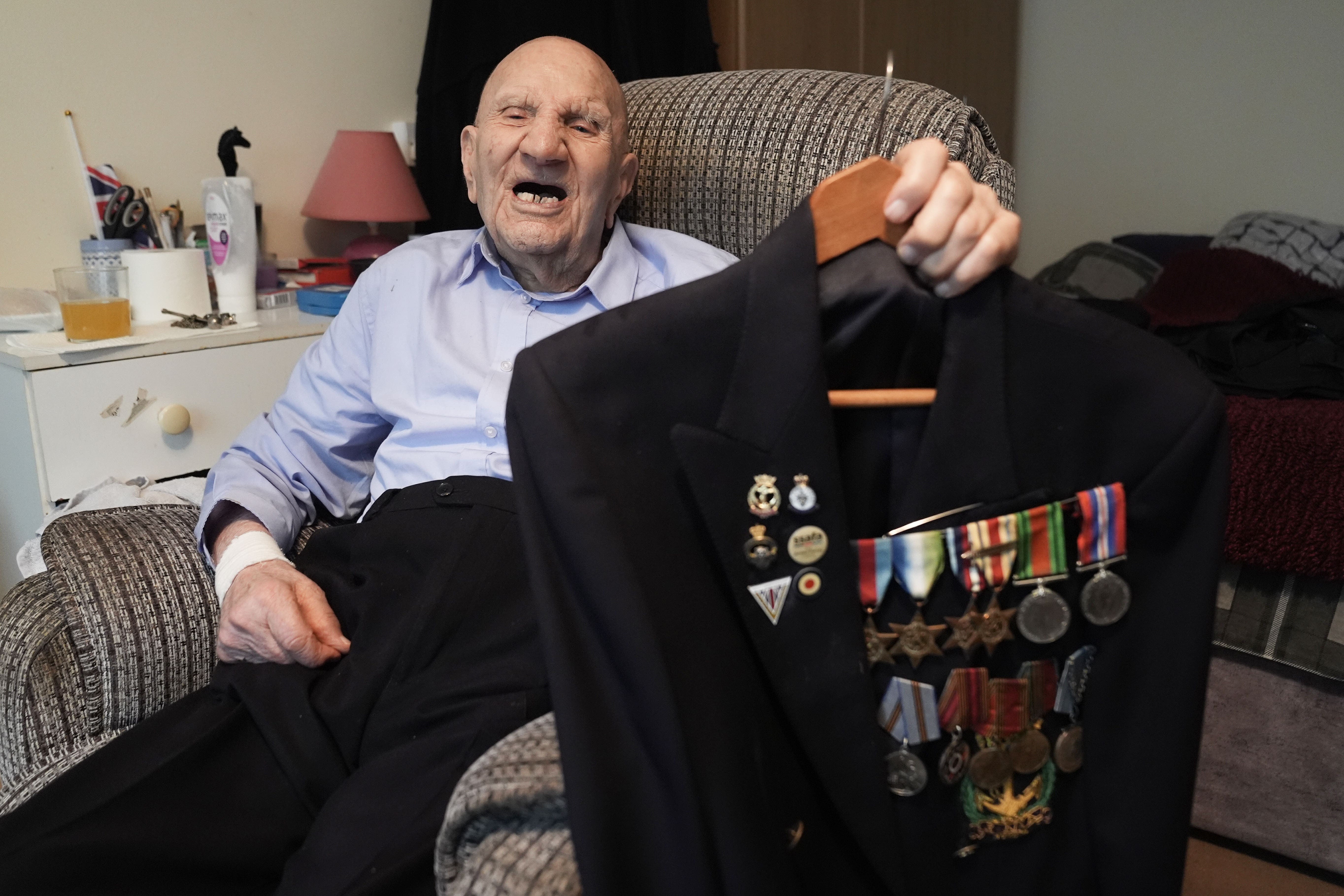 Second World War veteran Dougie Shelley, 99, shows off his medals (Stefan Rousseau/PA)