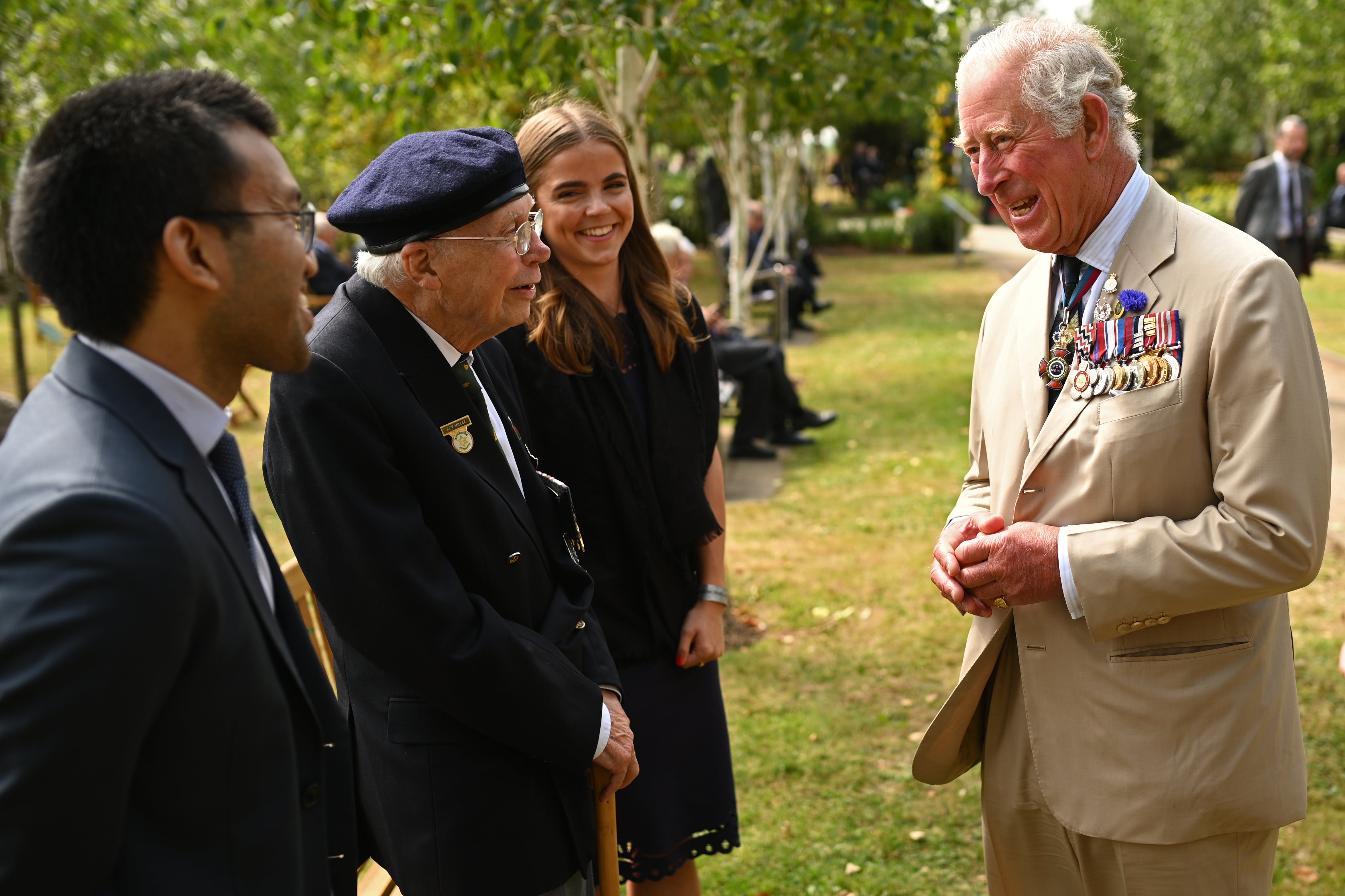 The then-Prince of Wales chats with a veteran after the national service of remembrance marking the 75th anniversary of VJ Day at the National Memorial Arboretum in 2020
