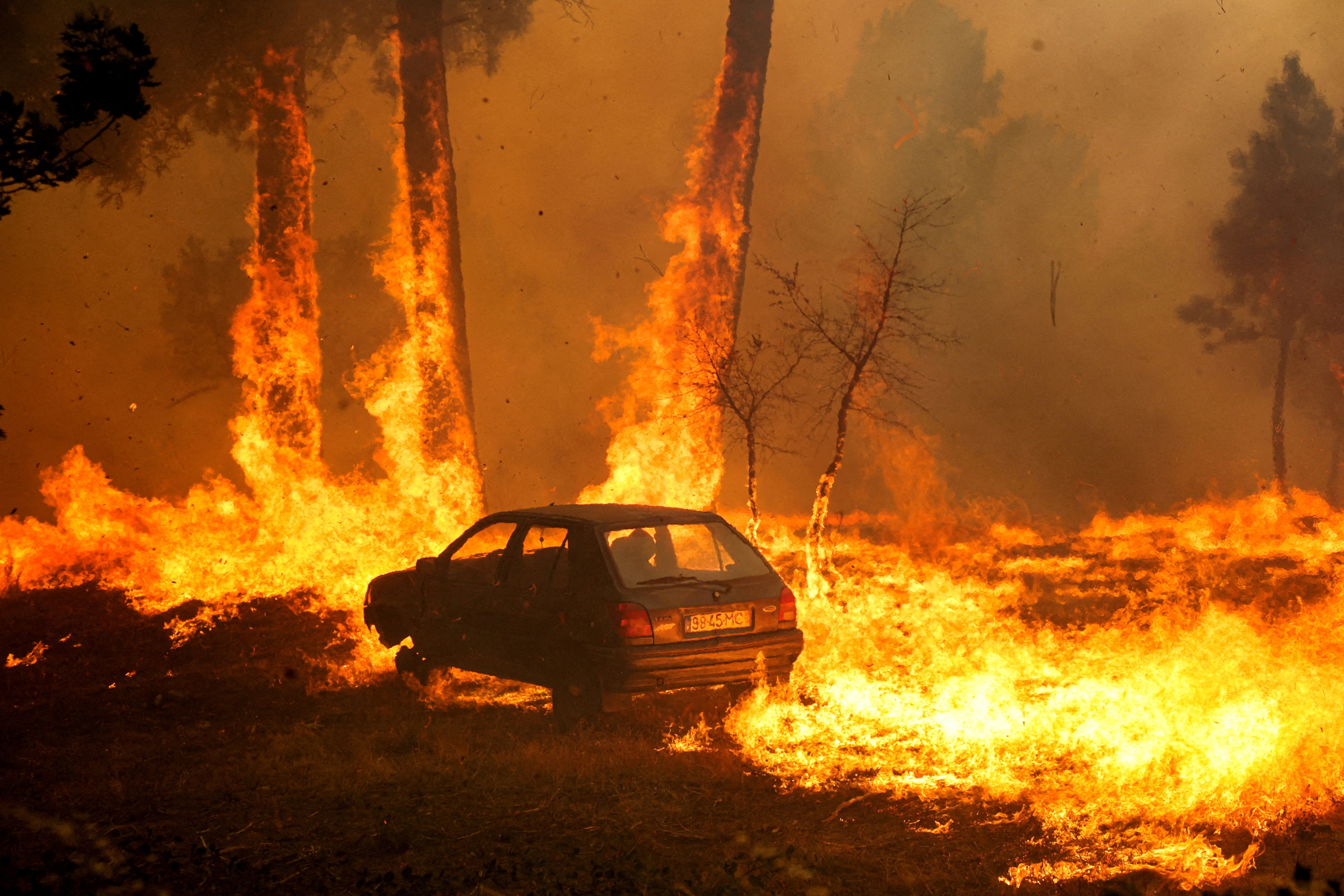 A car burns during the wildfire, in Meda, Portugal, August 15, 2025
