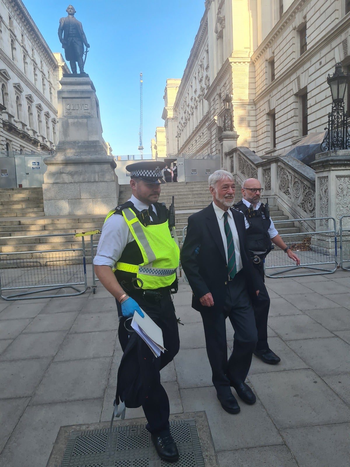 Col Romberg being escorted away from Parliament Square by police