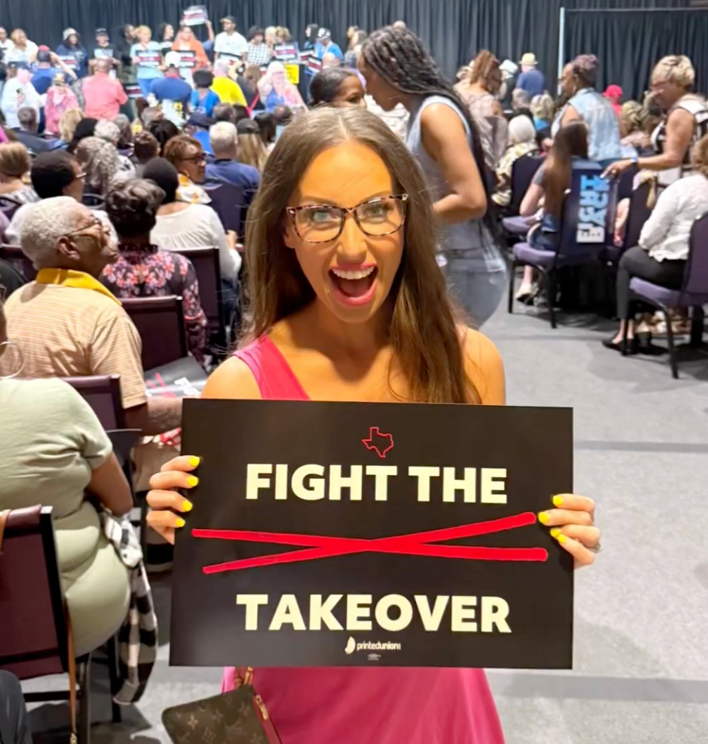 Blaze TV anchor Sara Gonzales poses with a sign before interrupting Democratic Rep. Jasmine Crockett's town hall in Dallas, Texas, on Thursday August 14 2025