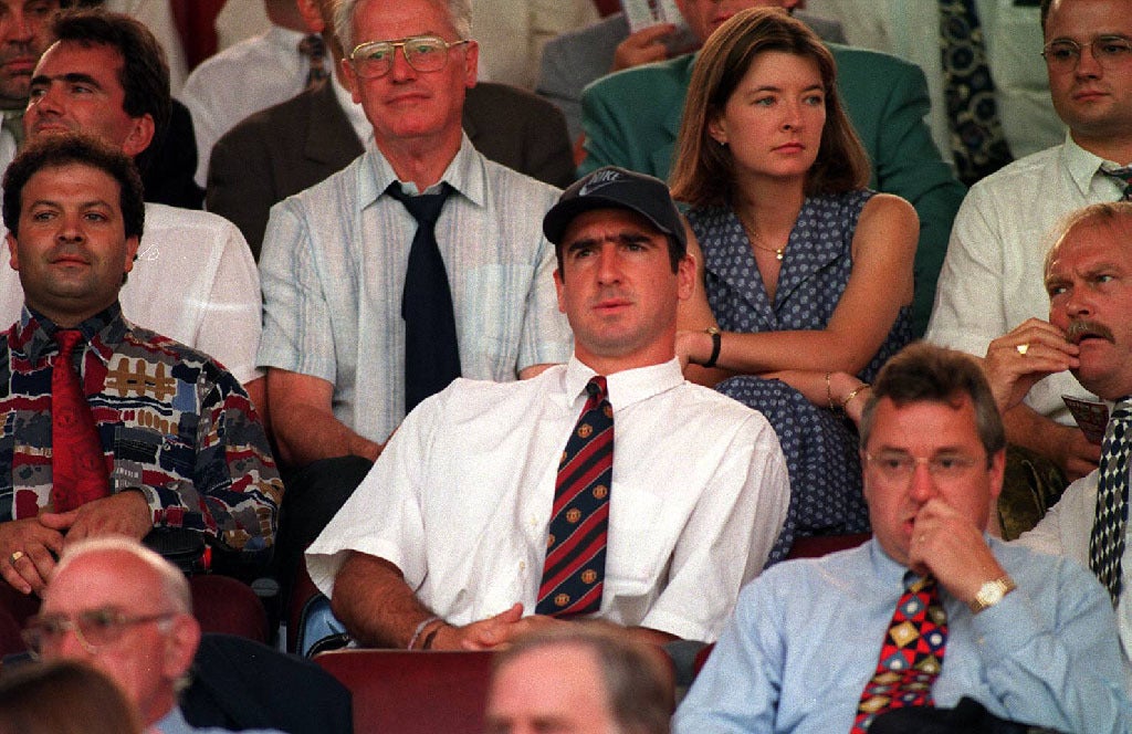Talisman Eric Cantona (centre, in cap) was suspended and watched from the stands as United went down 3-1 to Villa