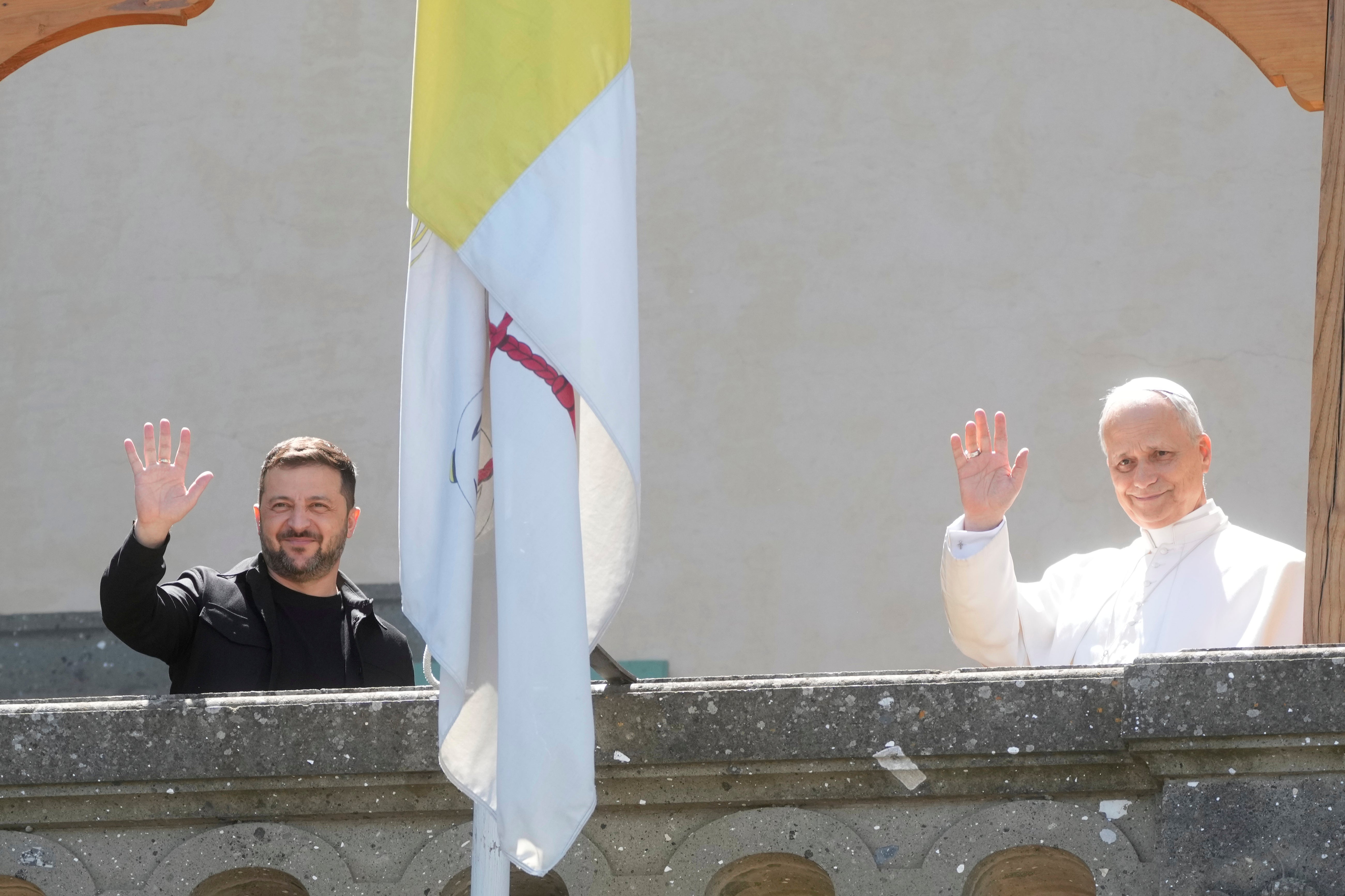 Ukraine President Volodymyr Zelenskyy, left, and Pope Leo XIV wave to journalists during their meeting in Castel Gandolfo, Italy, Wednesday, July 9, 2025. (AP Photo/Gregorio Borgia, File)