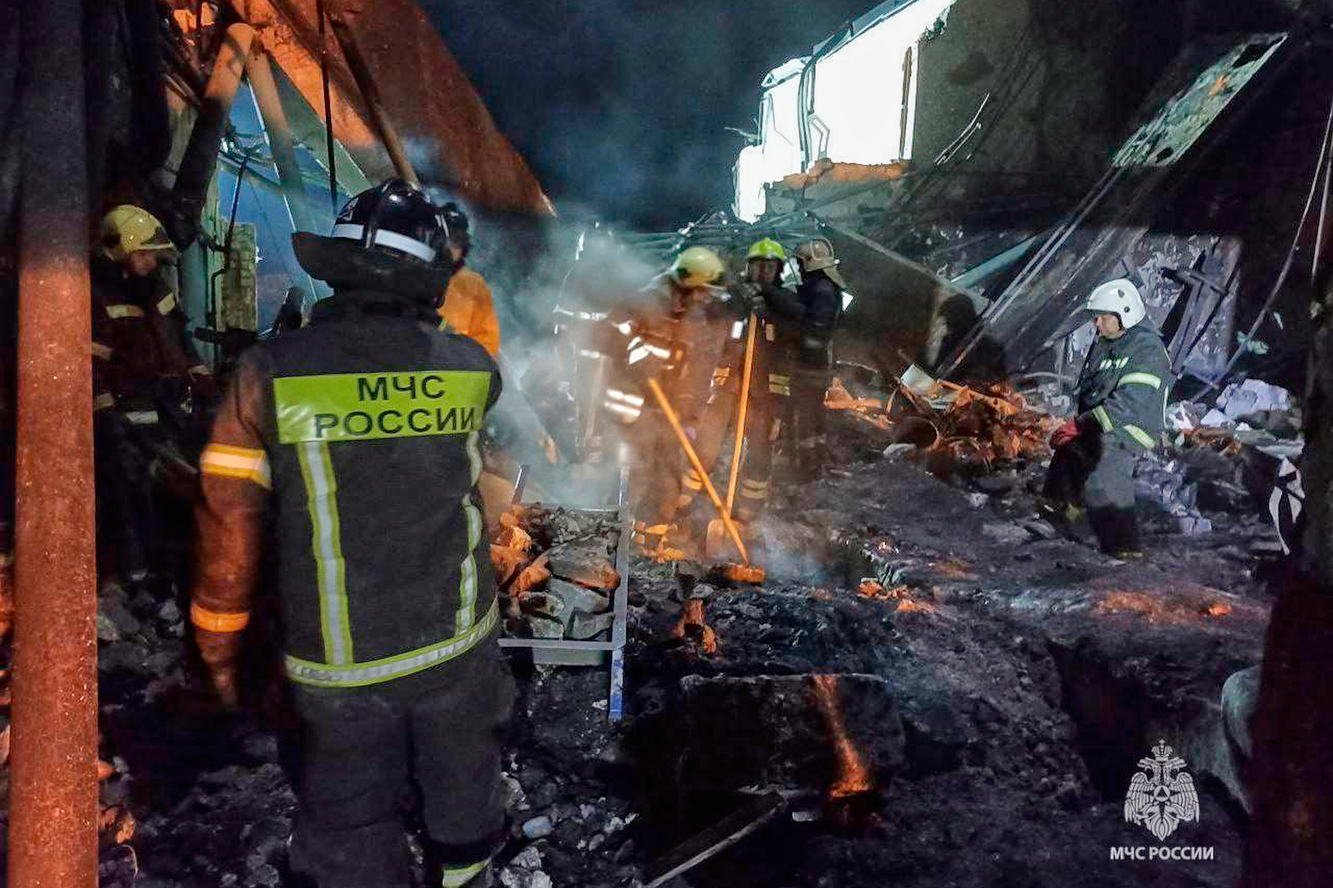 Emergency Ministry employees work in debris of an industrial plant after a fire at the facility in the Shilovsky District, Ryazan region, around 250 kilometers (155 miles) southeast of Moscow, Russia. (Russian Emergency Ministry Press Service via AP)