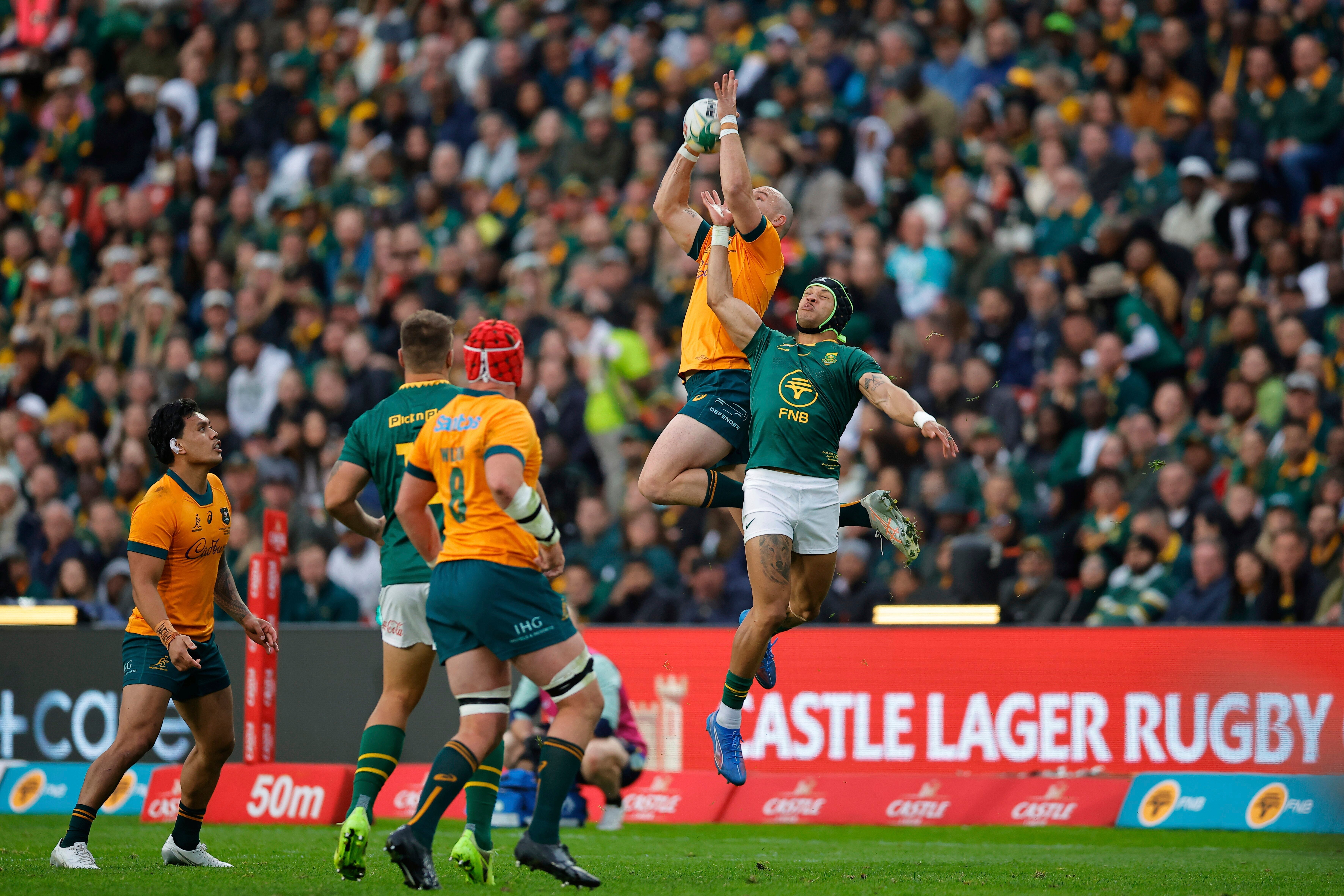 Australia's Dylan Pietsch, top left, jumps for the ball during a Rugby Championship
