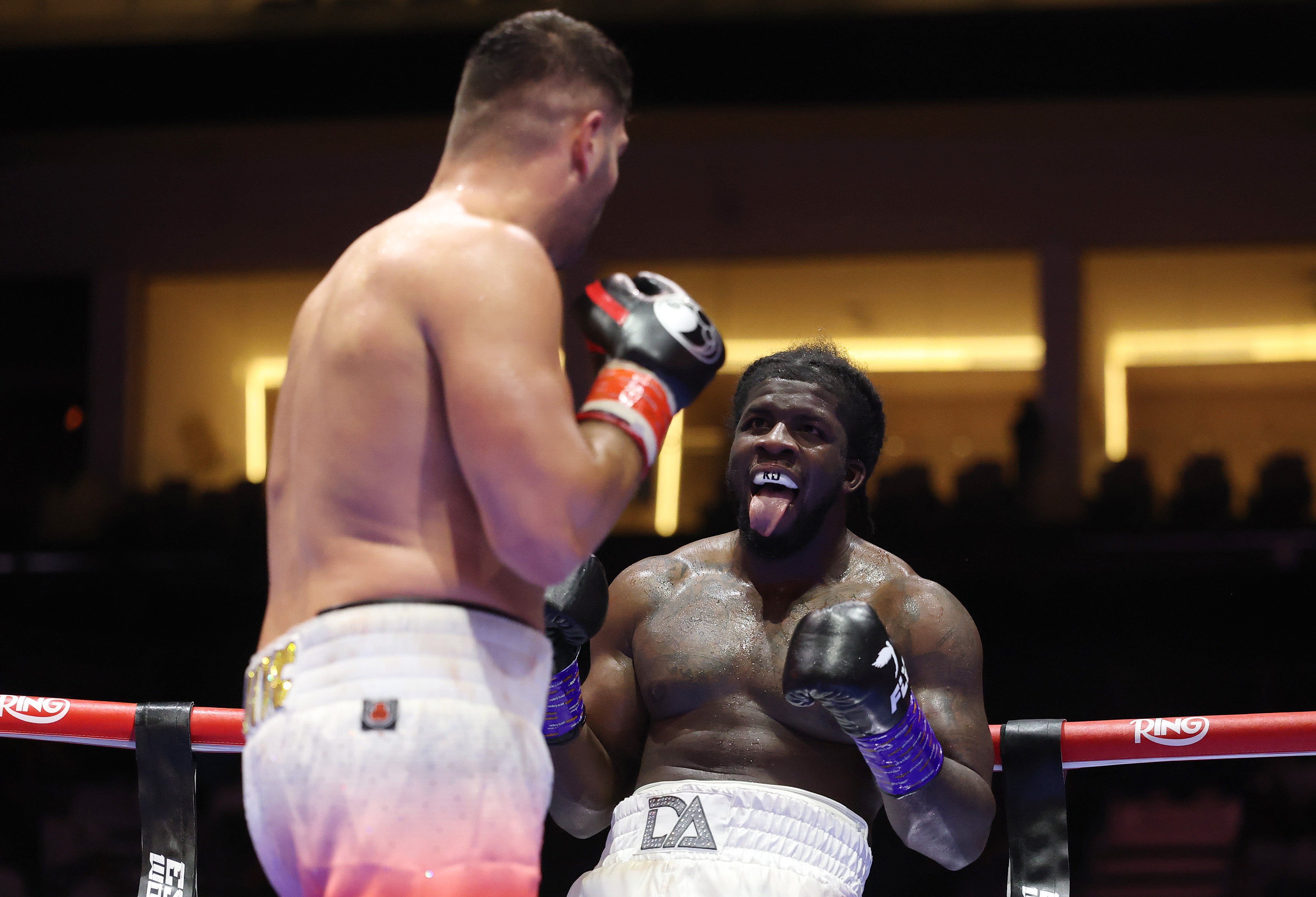 David Adeleye (left) sticks his tongue out in a losing effort against Filip Hrgovic