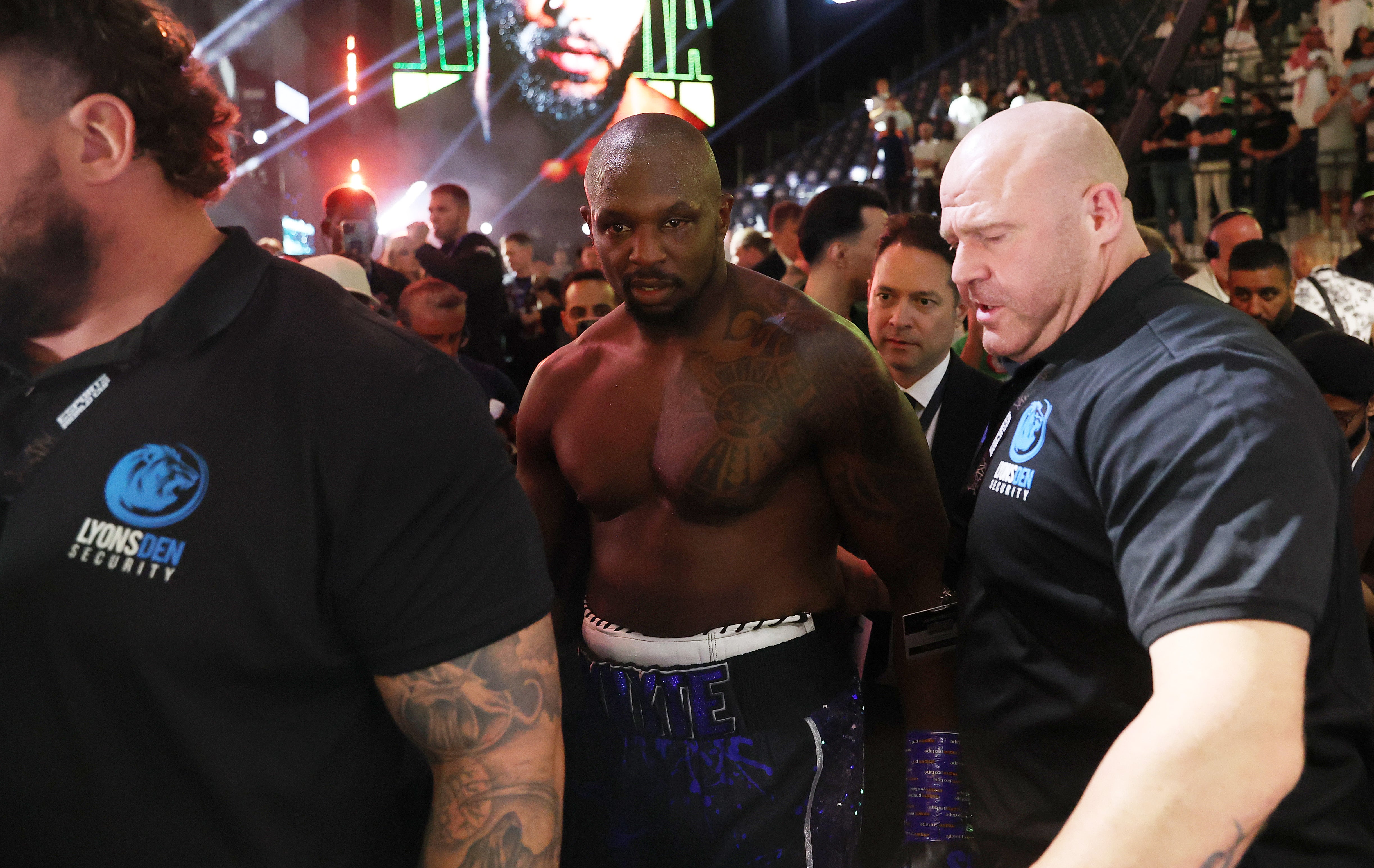 Dillian Whyte is guided out of the arena in Riyadh