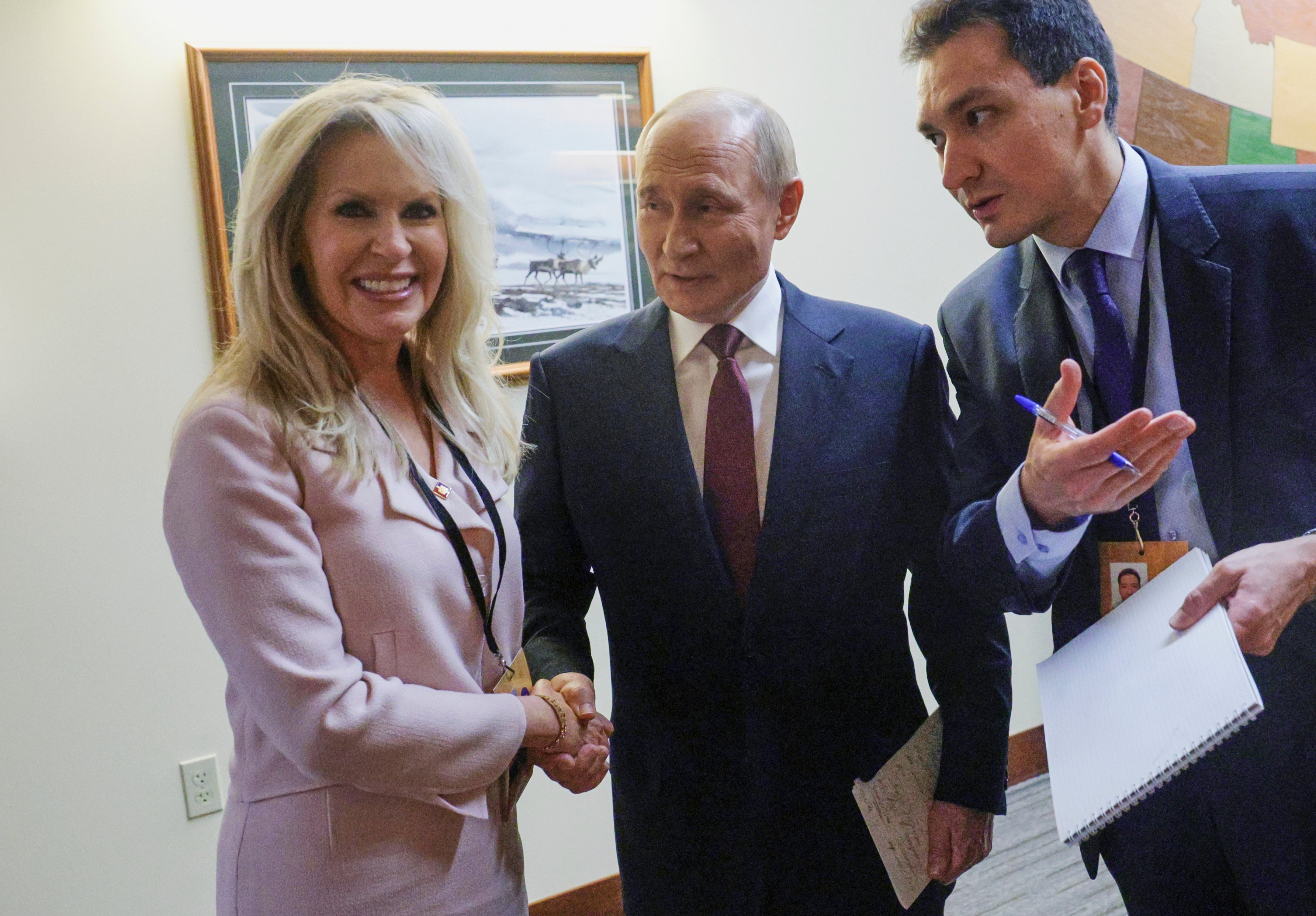 Russian President Vladimir Putin shakes hands with Chief of Protocol of the United States Monica Crowley after the Russian leader met with U.S. President Donald Trump