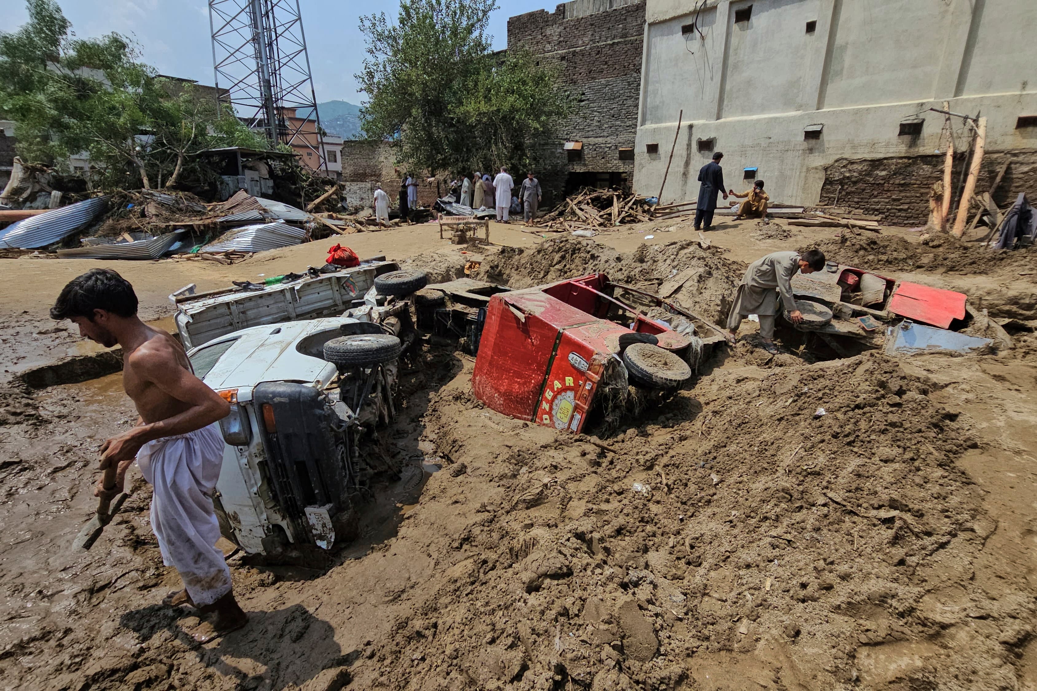 Local residents remove mud to recover vehicles from debris after Friday’s flash flooding, in Mingora, the main town of Swat Valley, in Pakistan’s northwest, Saturday, 16 August 2025. (AP Photo/Sherin Zada)