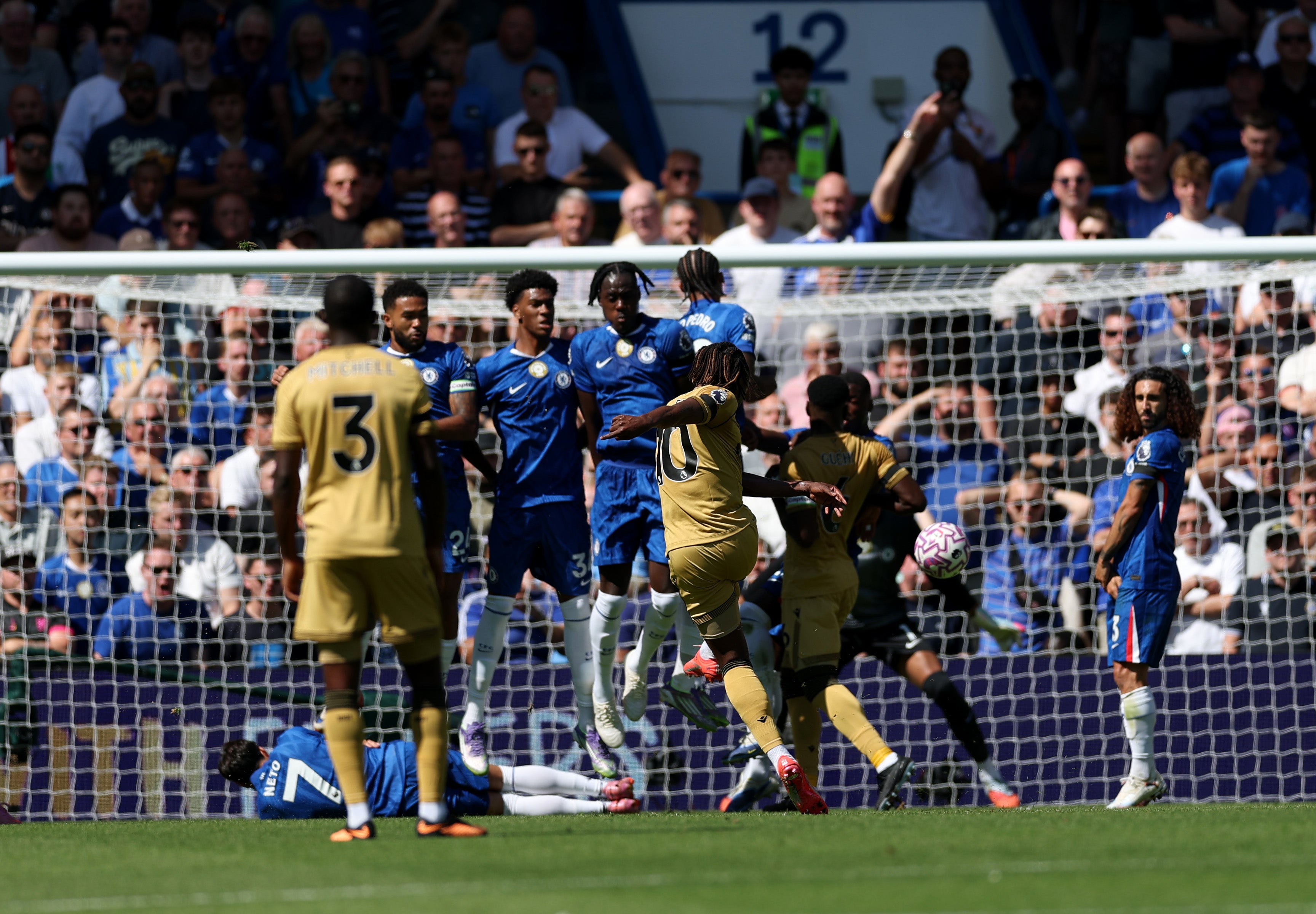 Eze strikes through the wall as Guehi bundles Caicedo out of the way