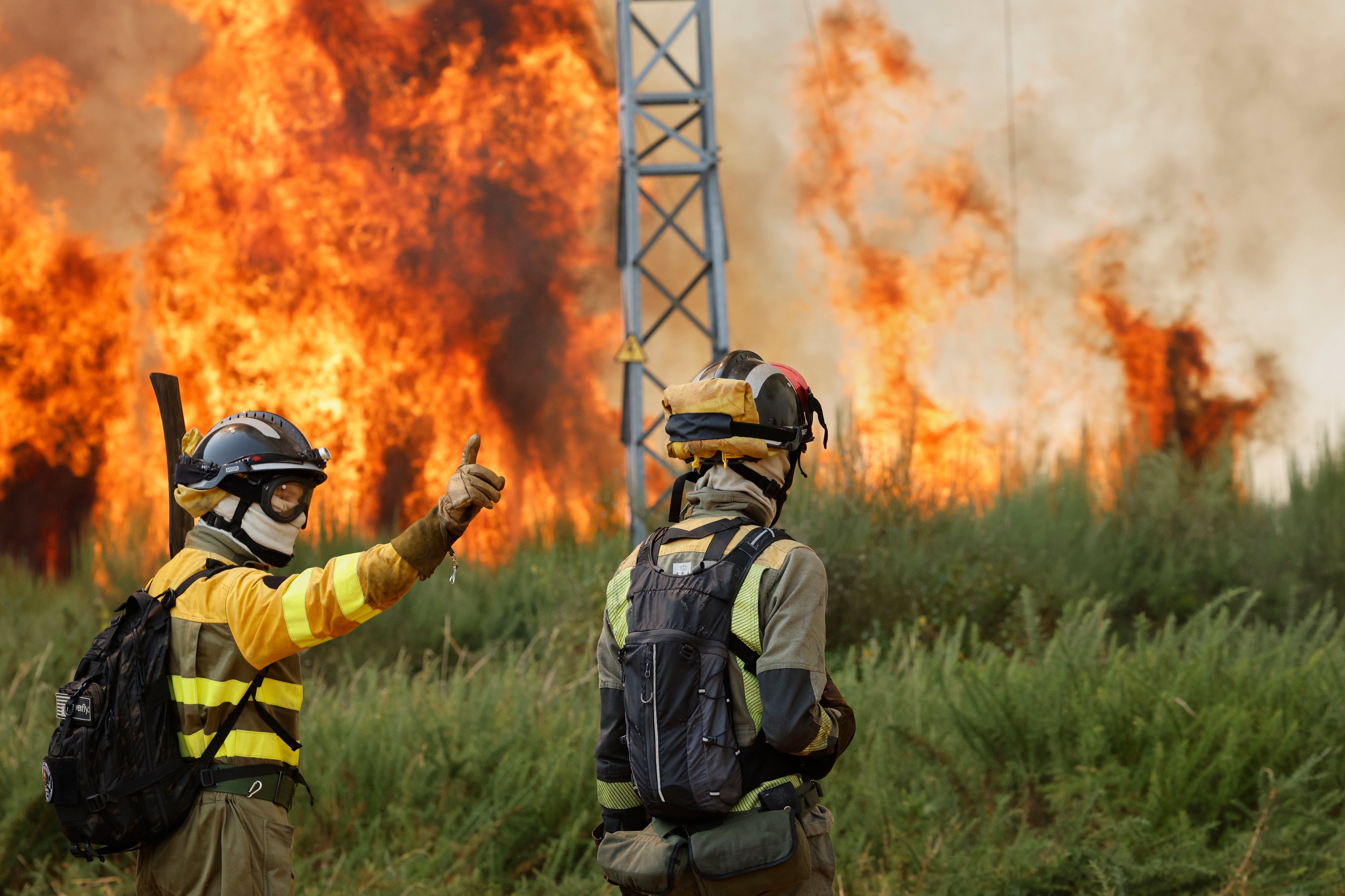 Firefighters battle a wildfire in Veiga das Meas, northwestern Spain on Saturday