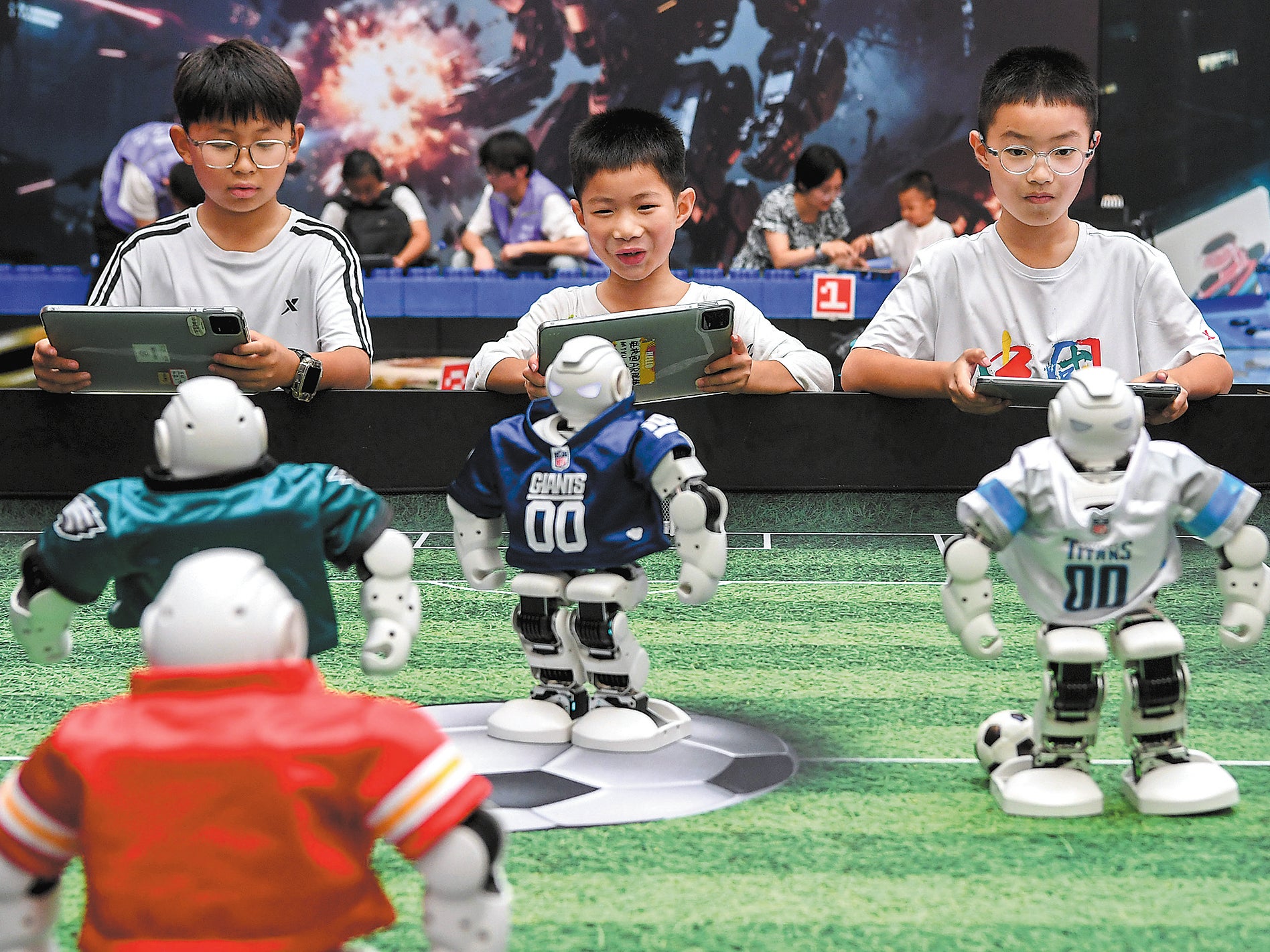 Children interact with football robots at a science museum in Jinhua, Zhejiang province, on 6 July