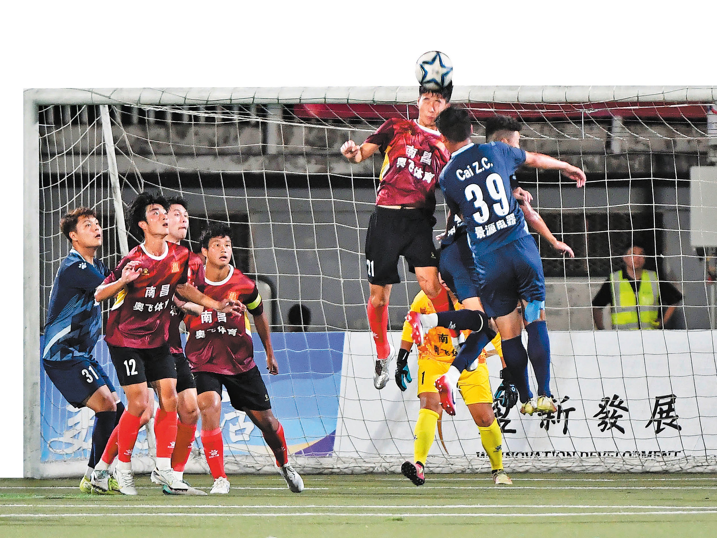 Nanchang and Jingdezhen players compete during the opening match of the Jiangxi Super League on 13 July in Nanchang, Jiangxi province
