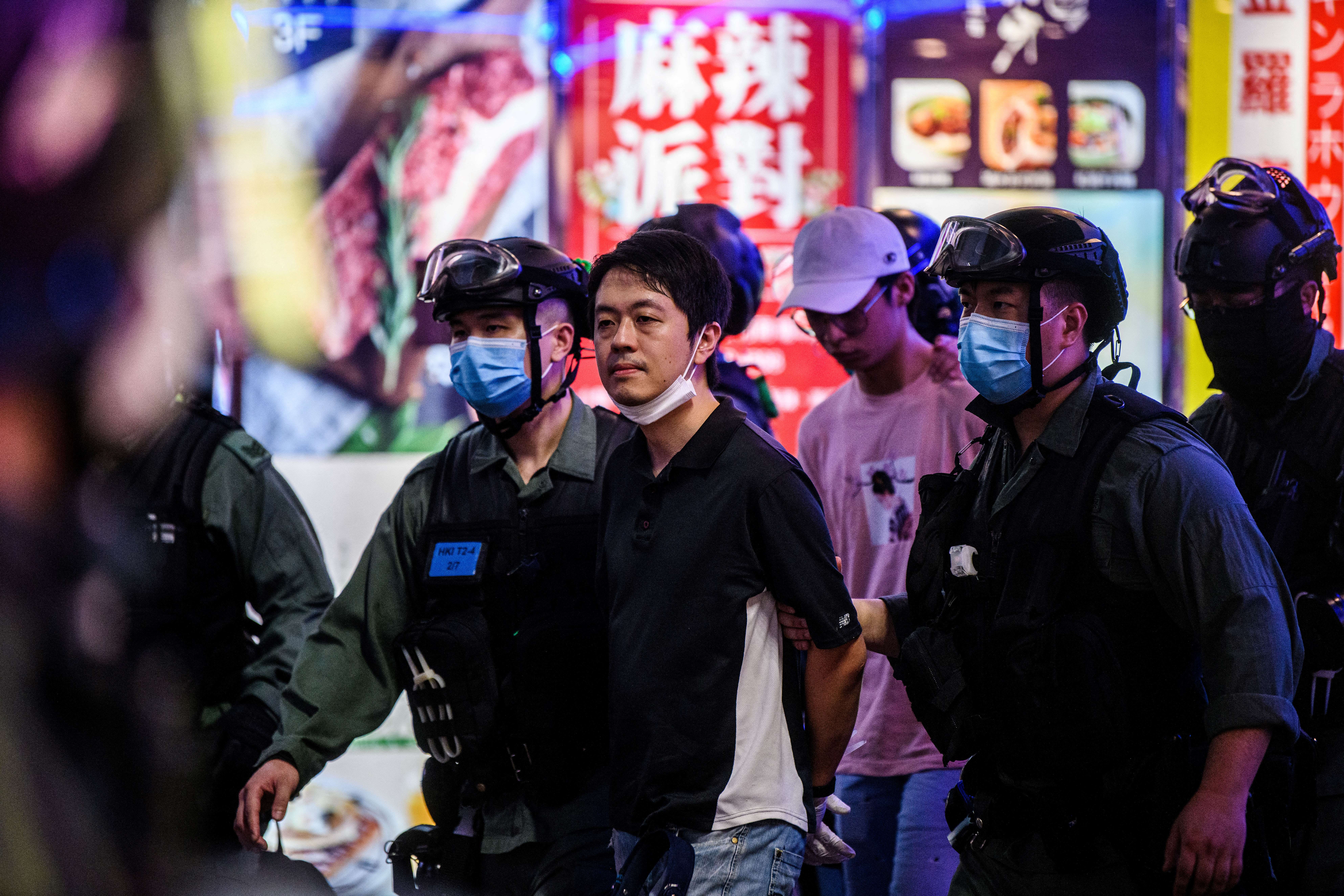 File Pro-democracy legislator Ted Hui (C) is detained by police during a pro-democracy rally in the Causeway Bay district of Hong Kong on June 12, 2020