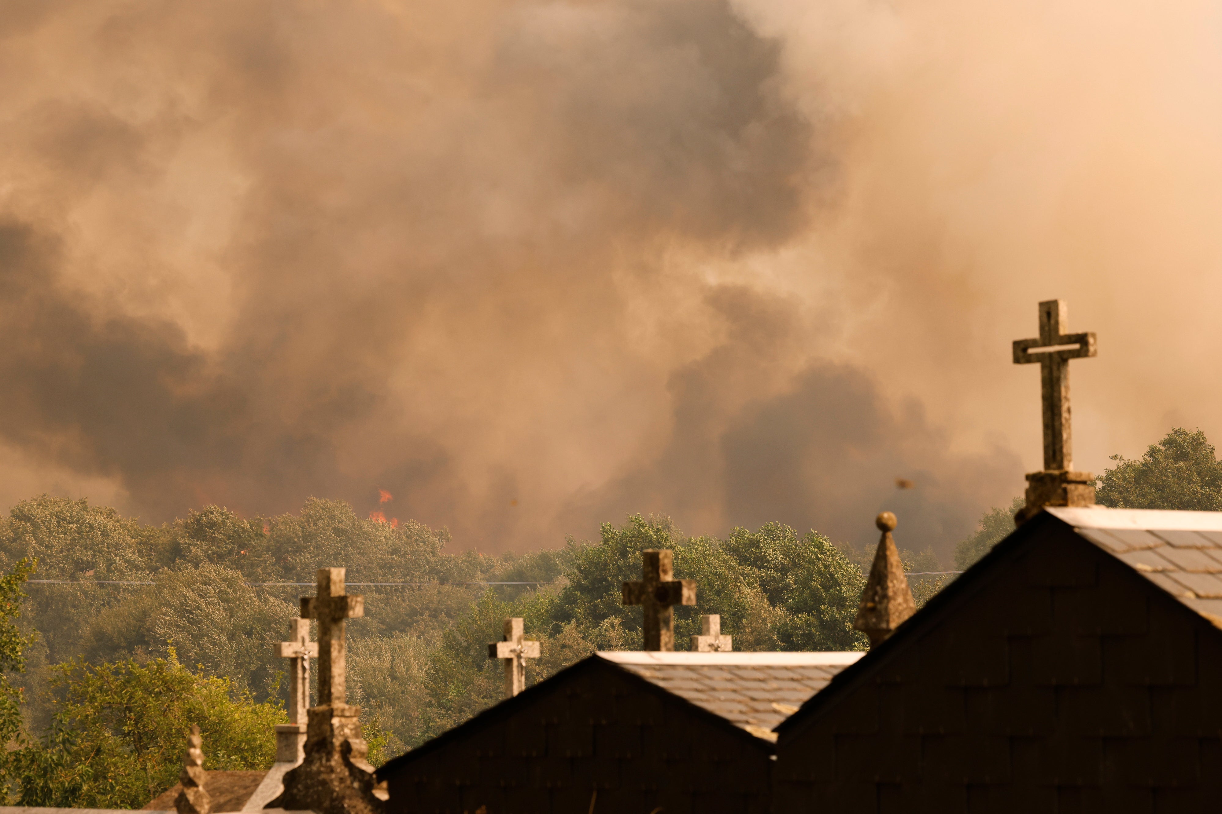 Plumes of smoke rise during a wildfire in Santa Baia De Montes, northwestern Spain