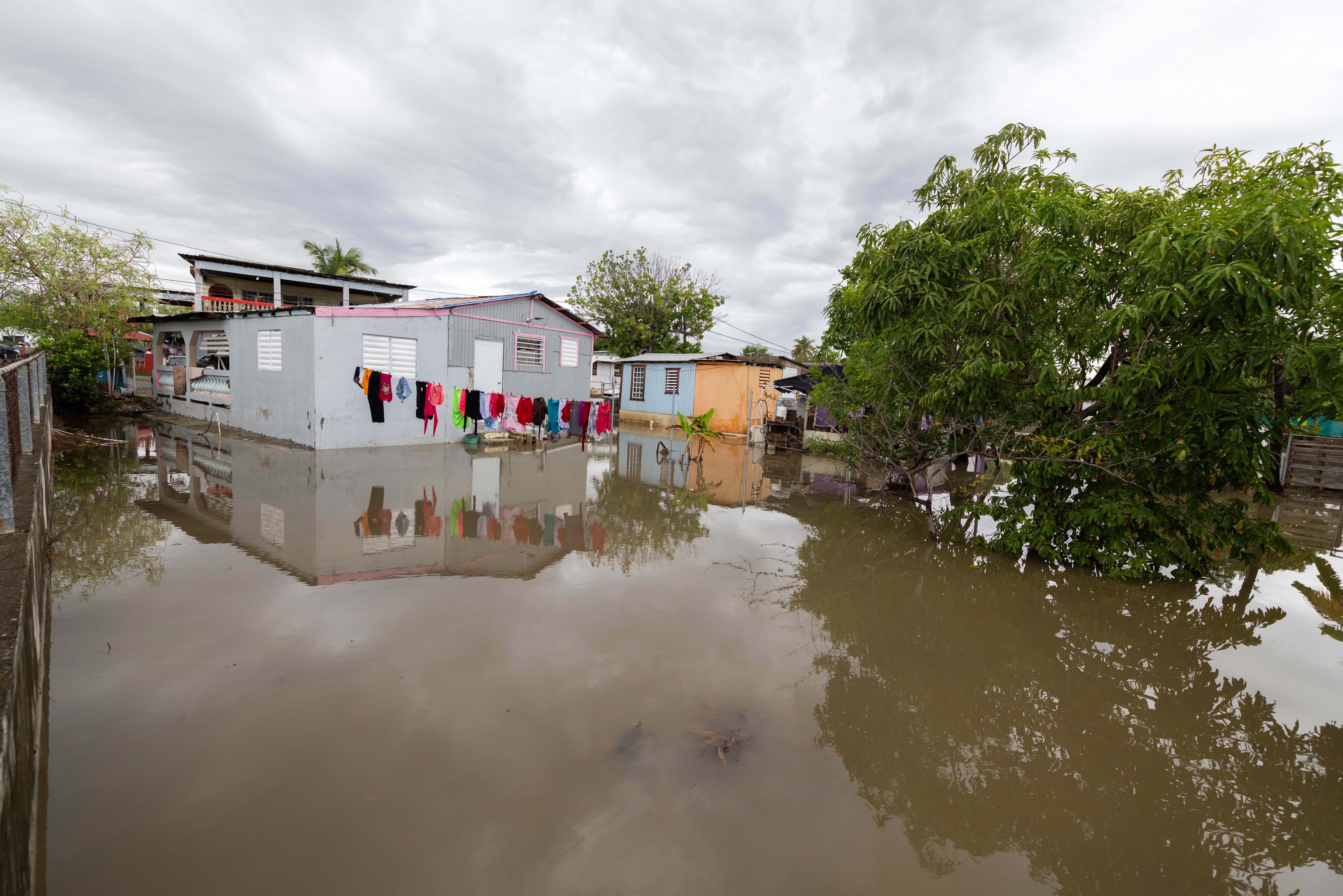 Water surrounds a house in Guayama, Puerto Rico, as Hurricane Erin brings rains to the island, Sunday, Aug. 17, 2025
